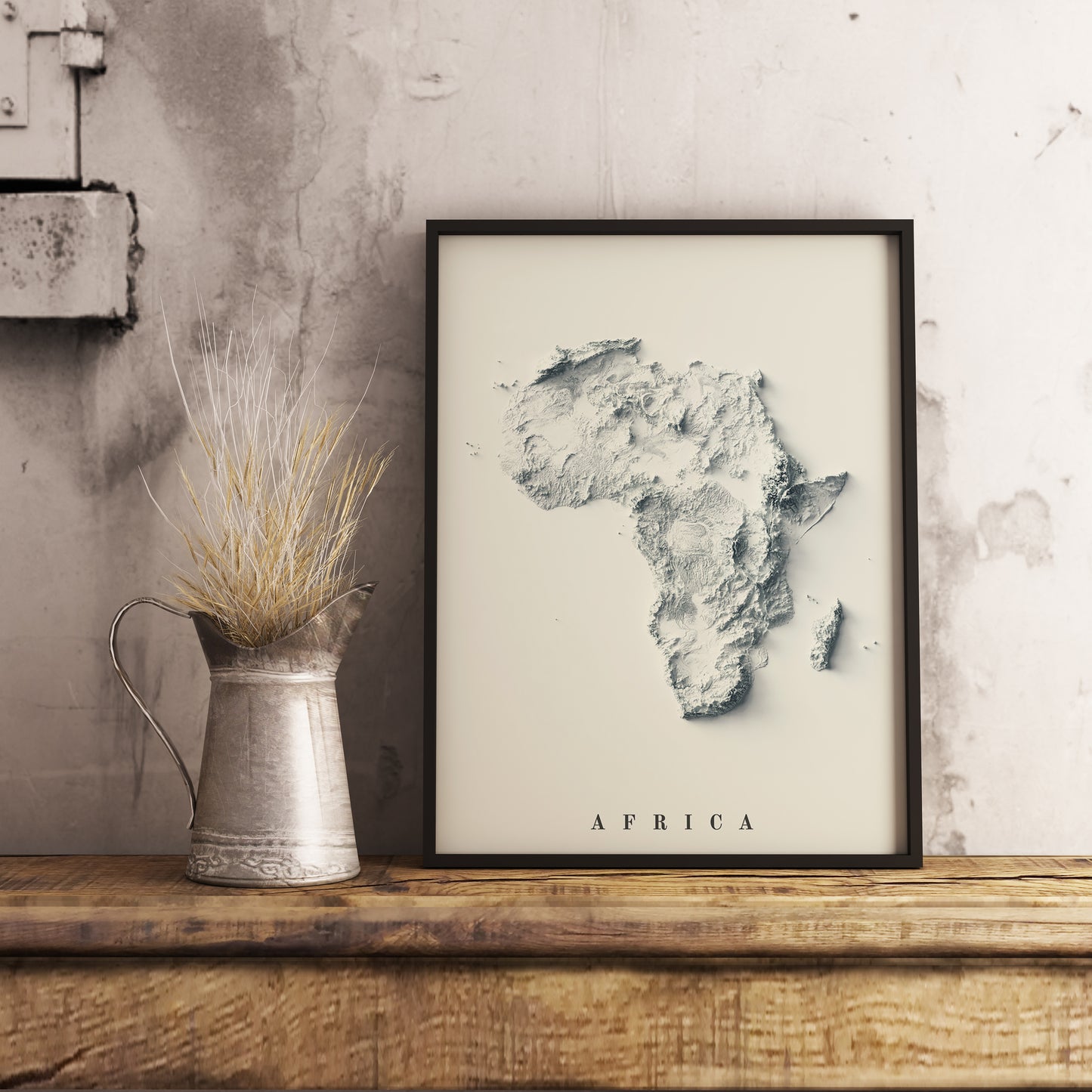 Africa shaded relief map in black frame. Realistic terrain art print for home decor, displayed on rustic wooden table