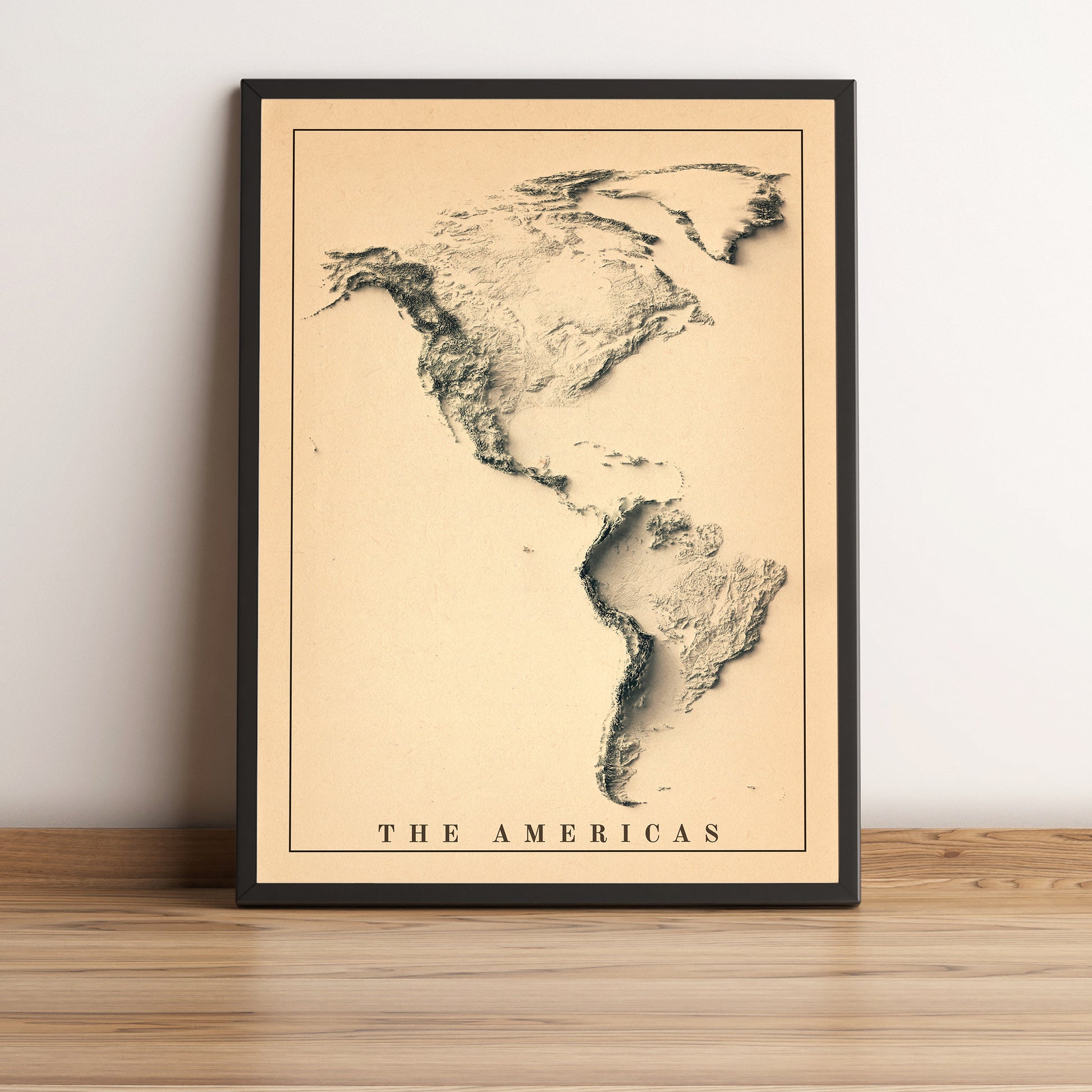 The American Continent vintage framed shaded relief map in black frame. Artistic print highlighting mountains with a realistic terrain effect