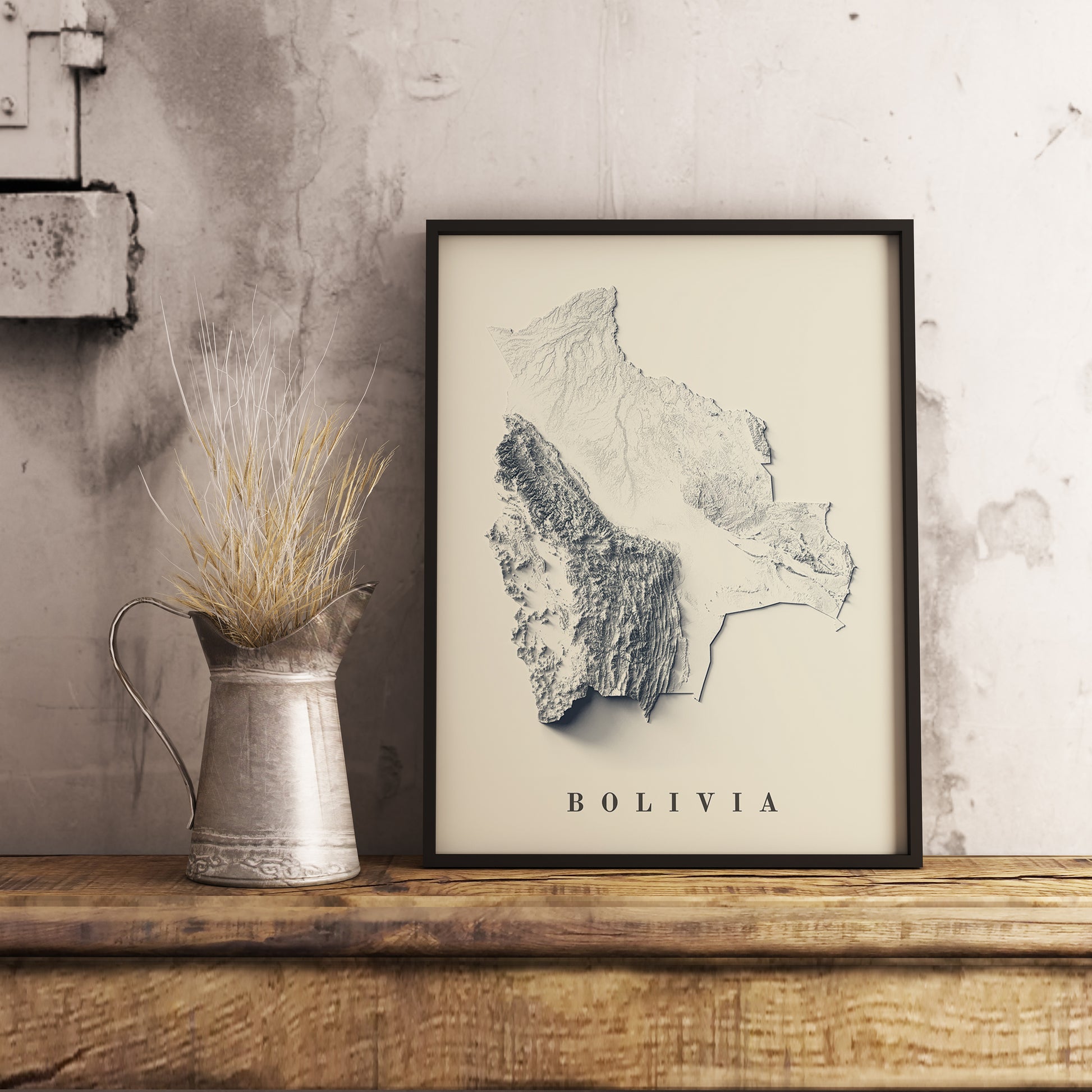 Vintage Bolivia shaded relief map in black frame. Realistic terrain art print for home decor, displayed on rustic wooden table