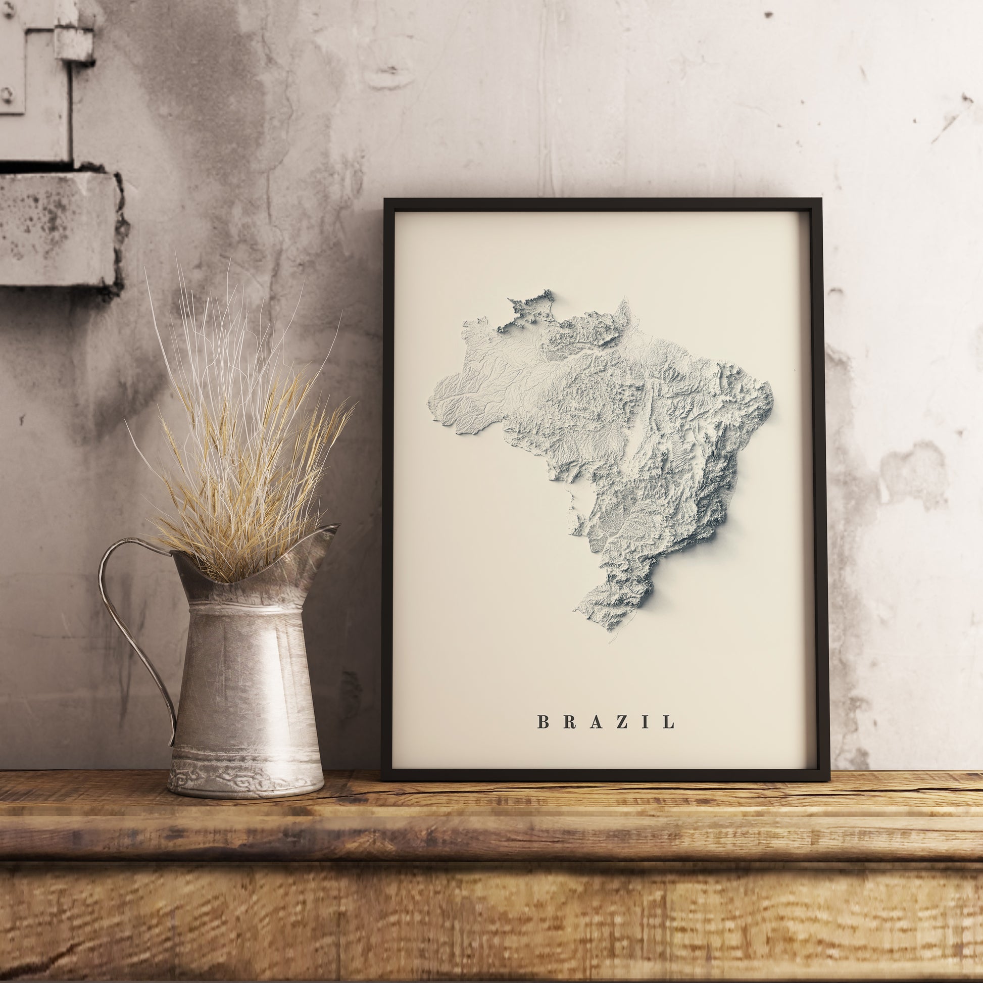 Vintage Brazil shaded relief map in black frame. Realistic terrain art print for home decor, displayed on rustic wooden table