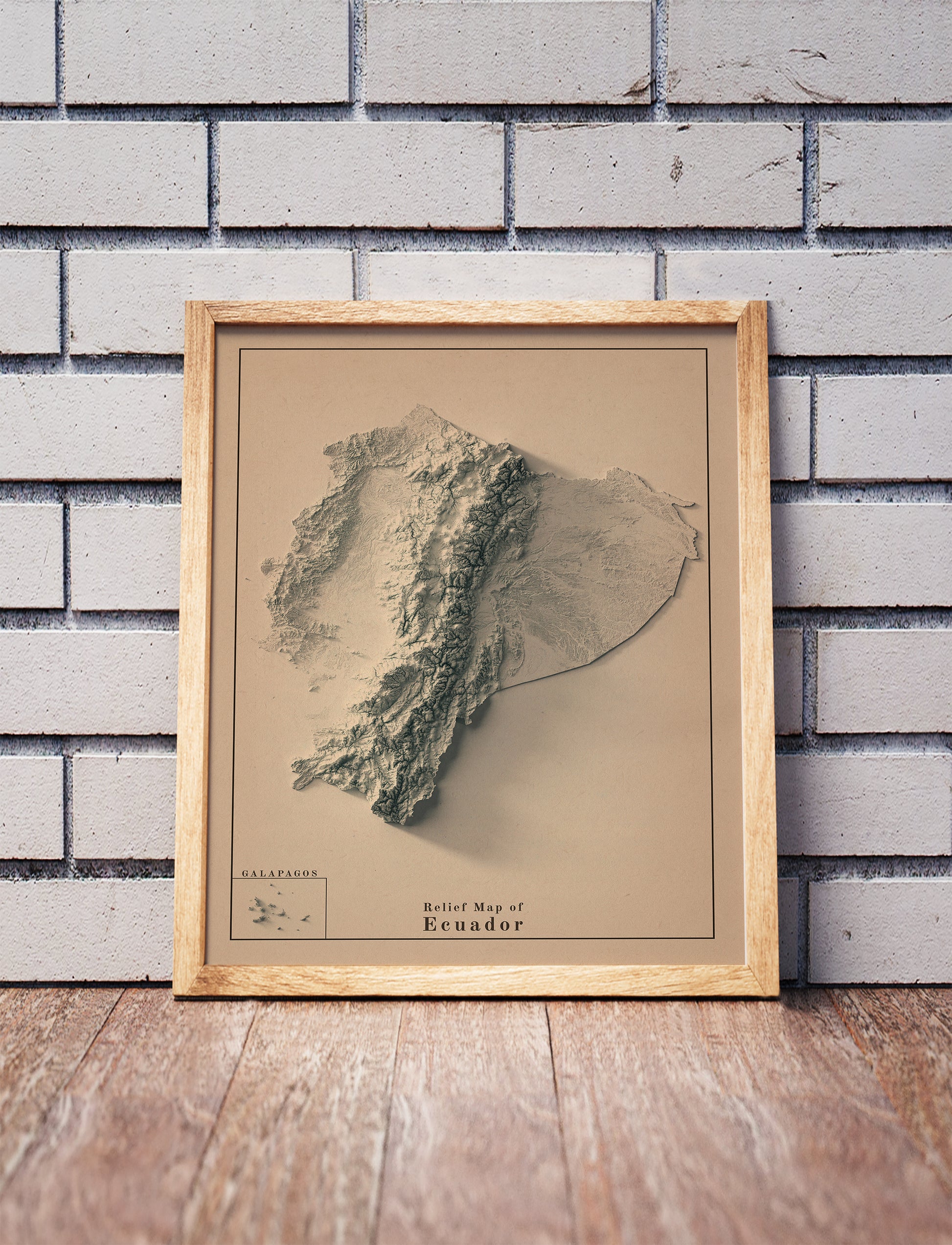 Vintage Ecuador shaded relief map in a wooden frame. Realistic terrain art print for home decor, displayed against a brick wall