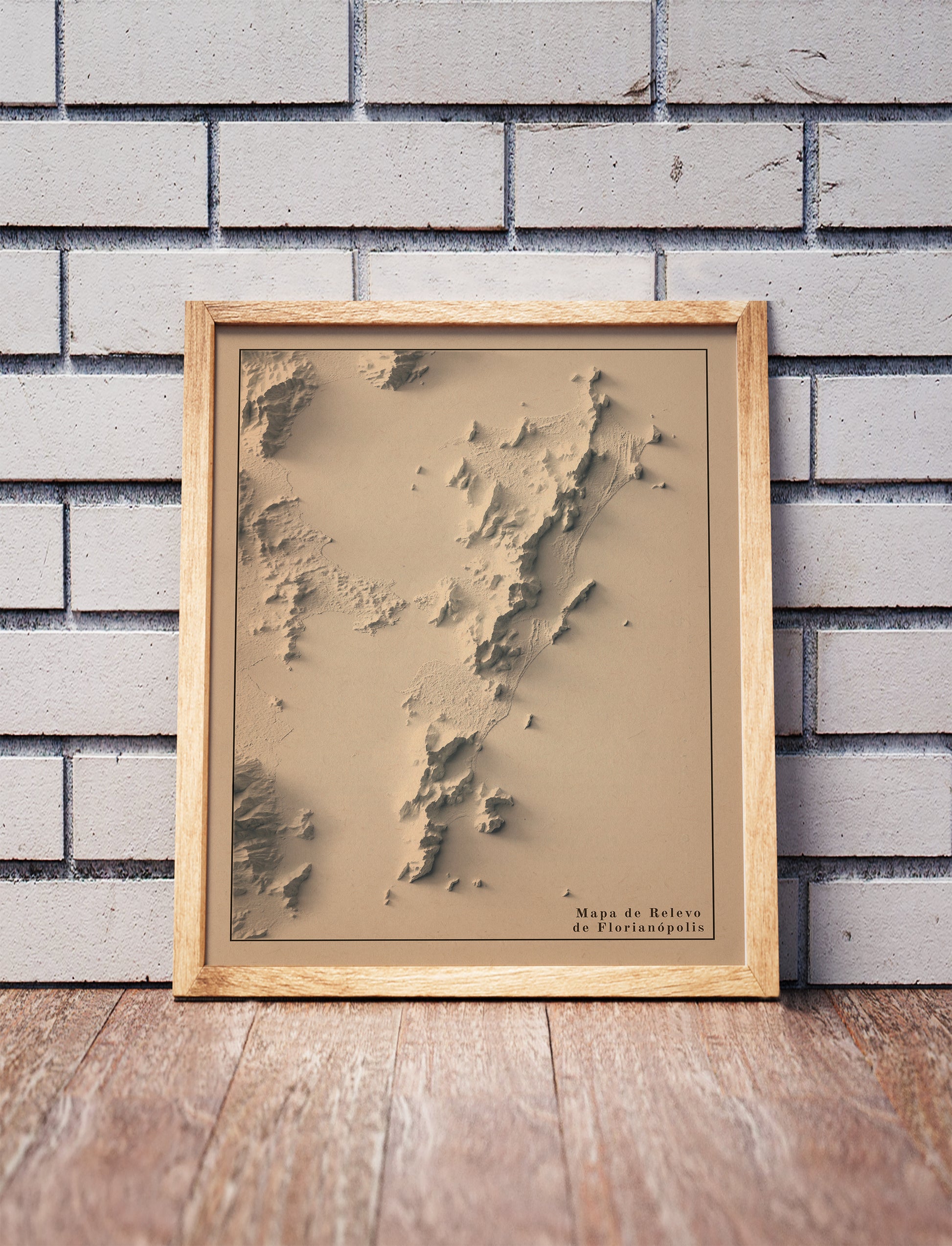 Vintage Florianopolis (Brazil) shaded relief map in a wooden frame. Realistic terrain art print for home decor, displayed against a brick wall
