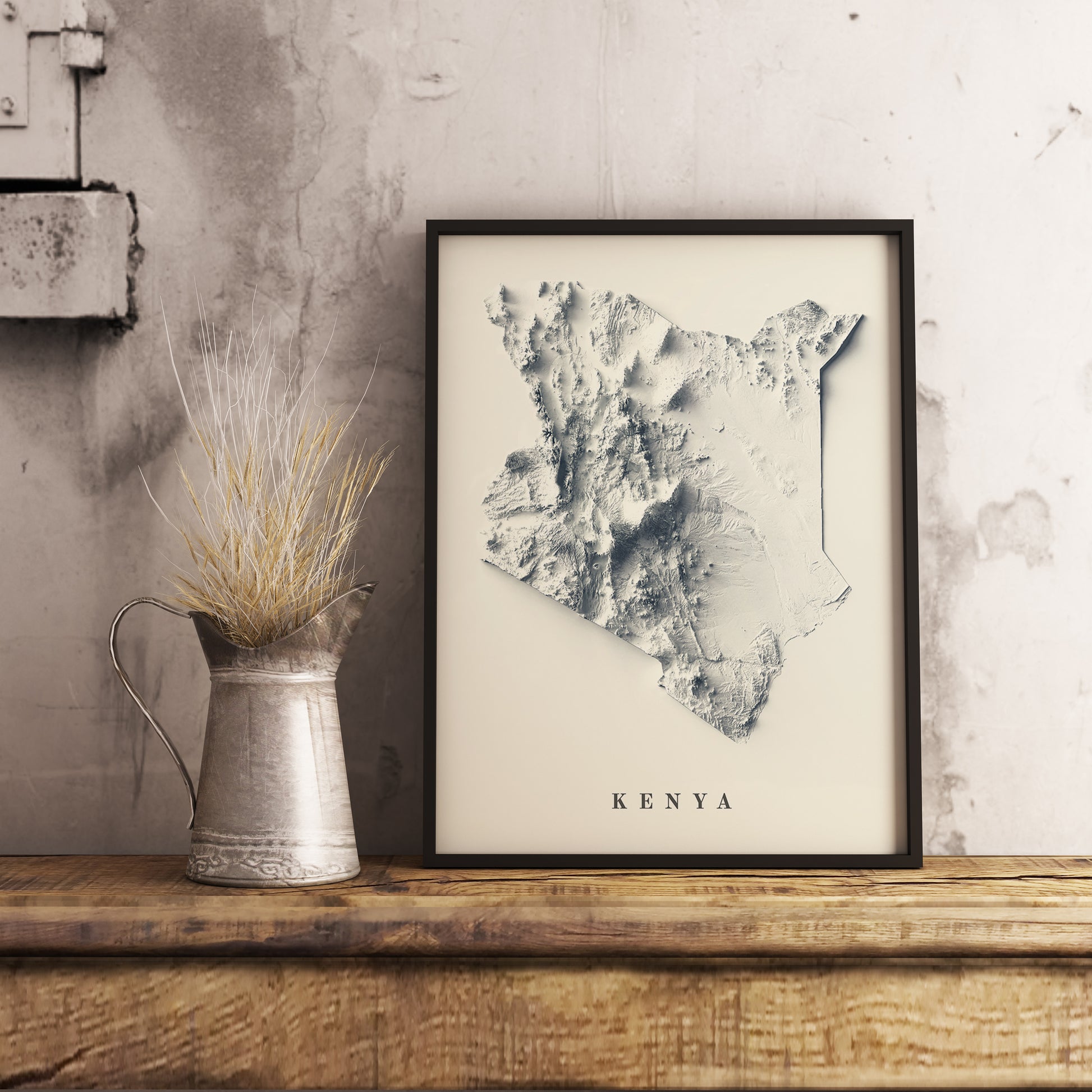 Kenya shaded relief map in black frame. Realistic terrain art print for home decor, displayed on rustic wooden table