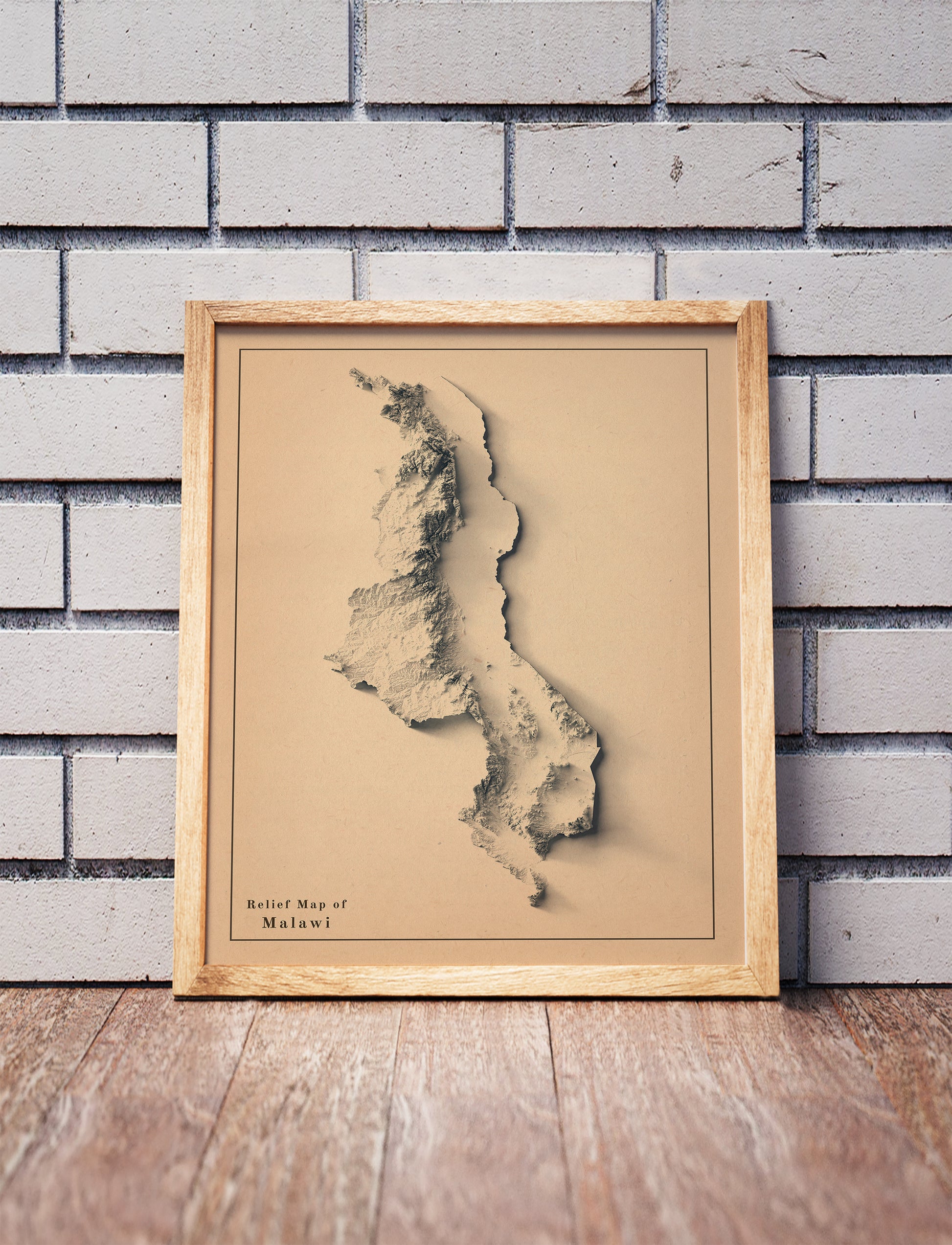 Vintage Malawi shaded relief map in a wooden frame. Realistic terrain art print for home decor, displayed against a brick wall