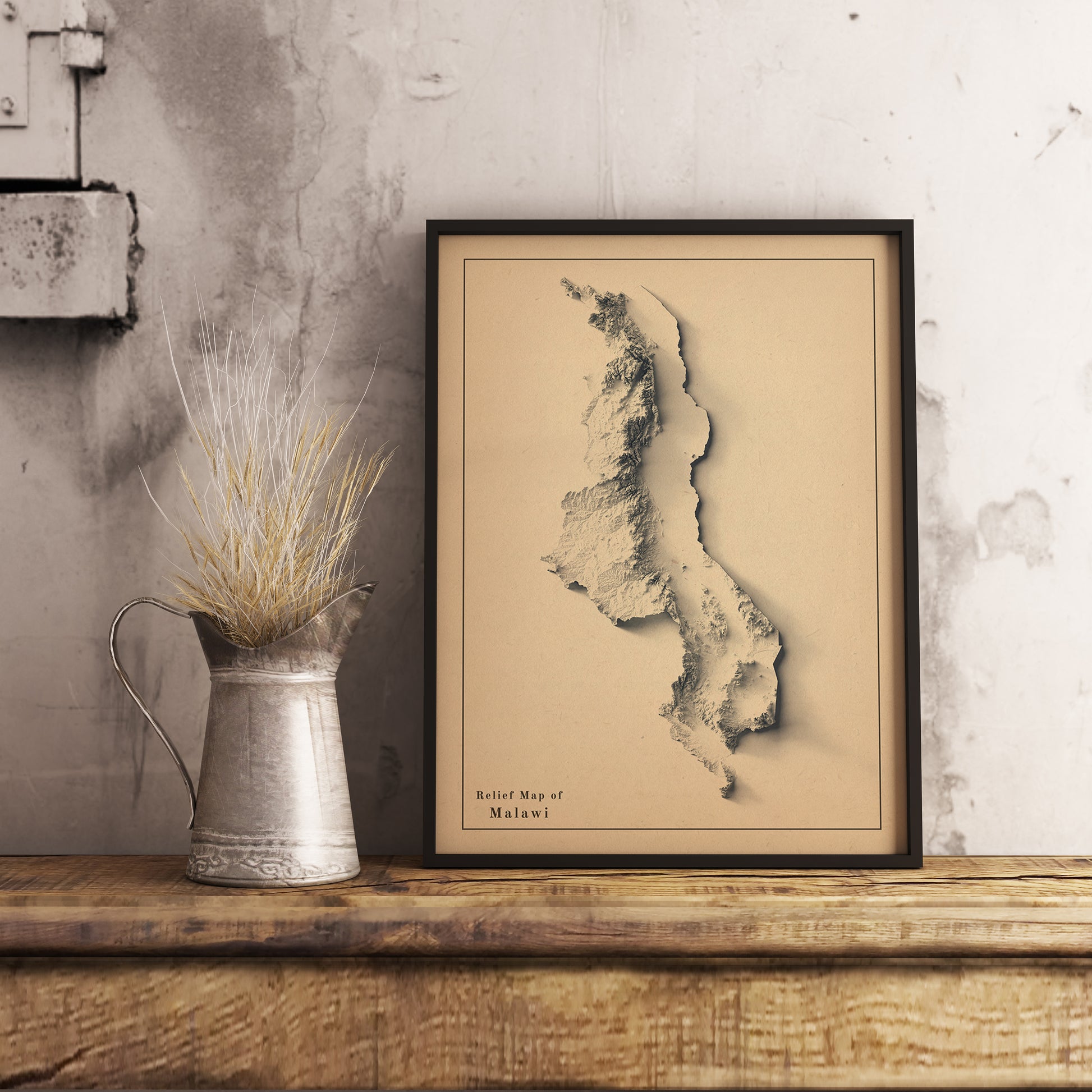 Vintage Malawi shaded relief map in black frame. Realistic terrain art print for home decor, displayed on rustic wooden table