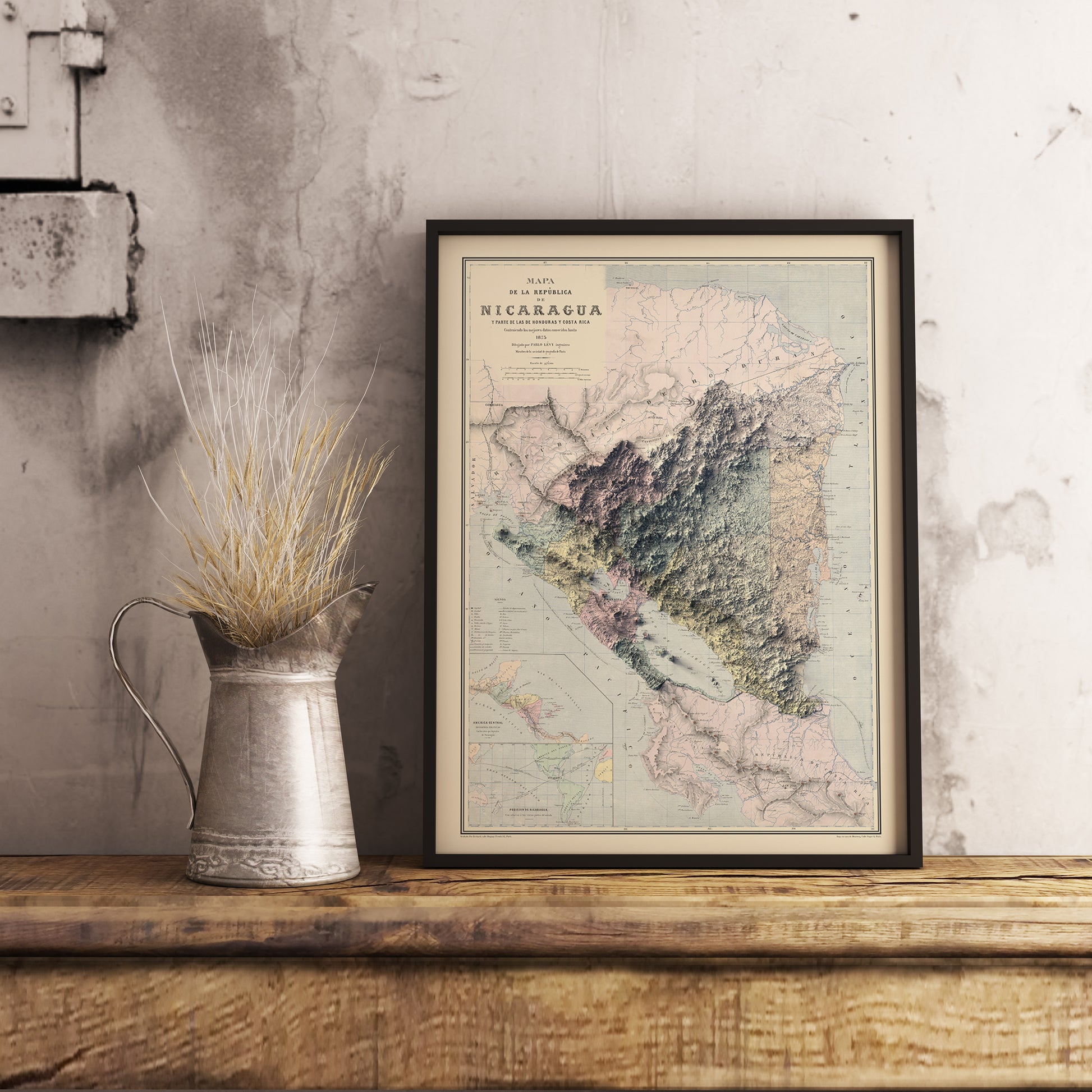 Vintage Nicaragua shaded relief map in black frame. Realistic terrain art print for home decor, displayed on rustic wooden table