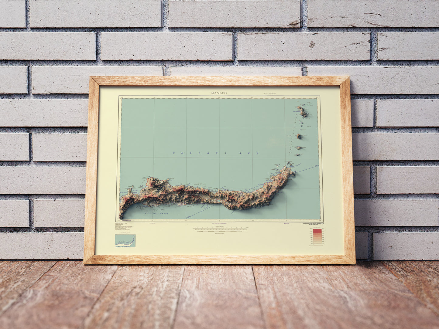 North Sulawesi, Celebes, Indonesia shaded relief map in a wooden frame. Realistic terrain art print for home decor, displayed against a brick wall