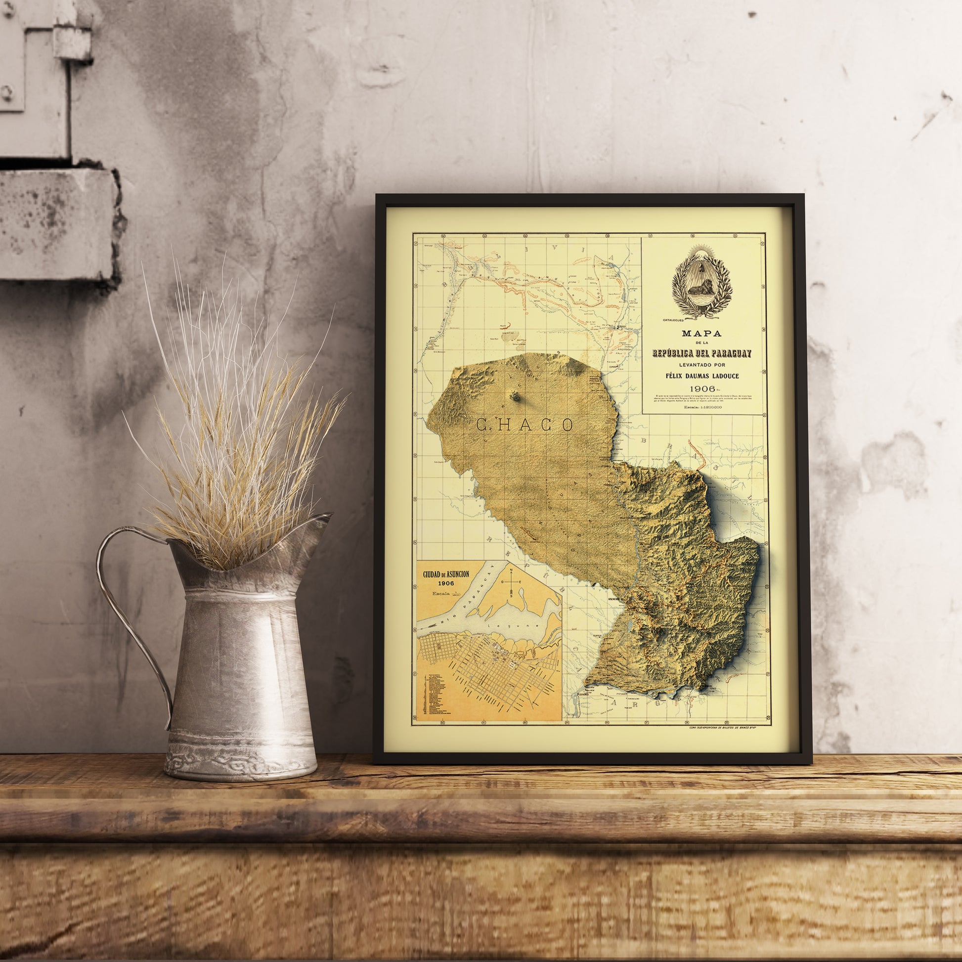 Vintage Paraguay shaded relief map in black frame. Realistic terrain art print for home decor, displayed on rustic wooden table