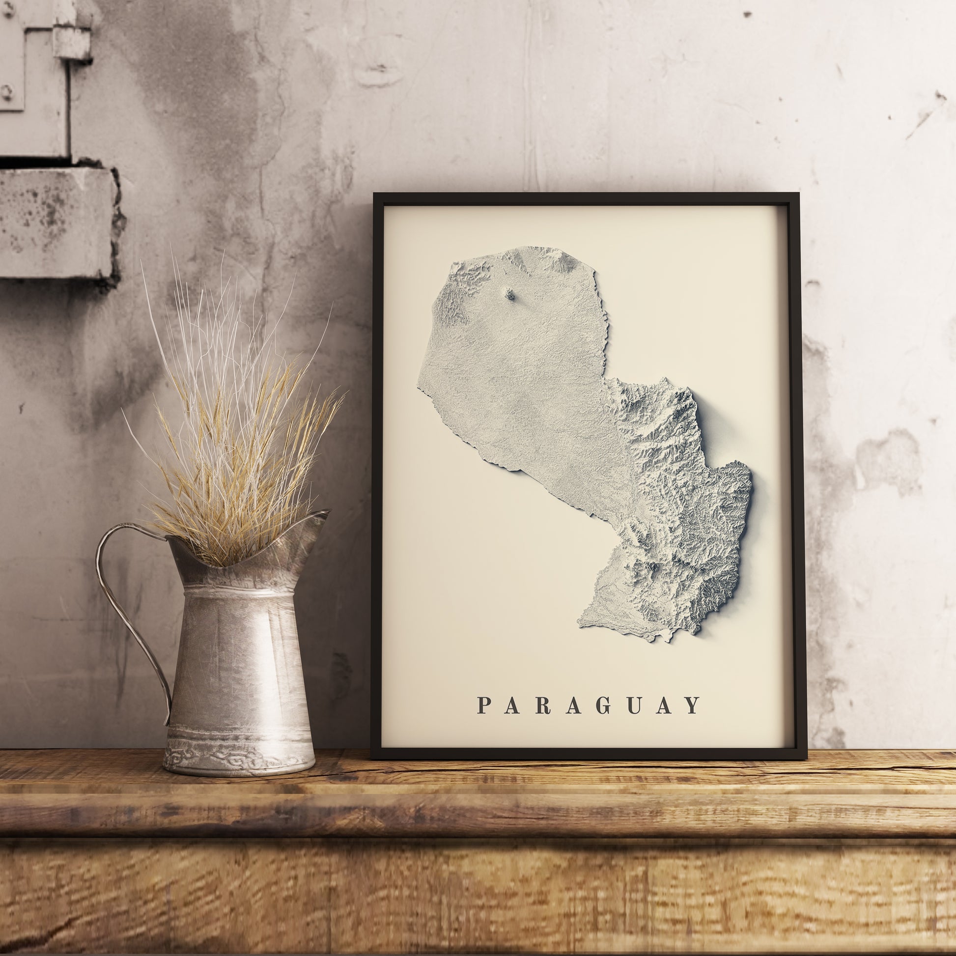 Paraguay shaded relief map in black frame. Realistic terrain art print for home decor, displayed on rustic wooden table