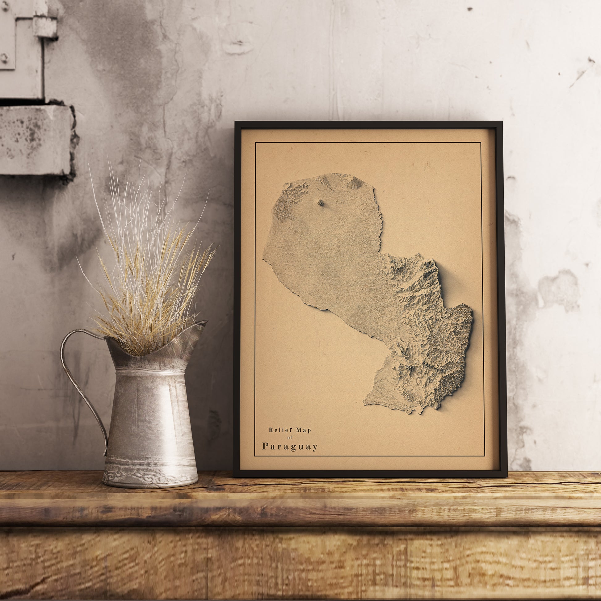 Vintage Paraguay shaded relief map in black frame. Realistic terrain art print for home decor, displayed on rustic wooden table