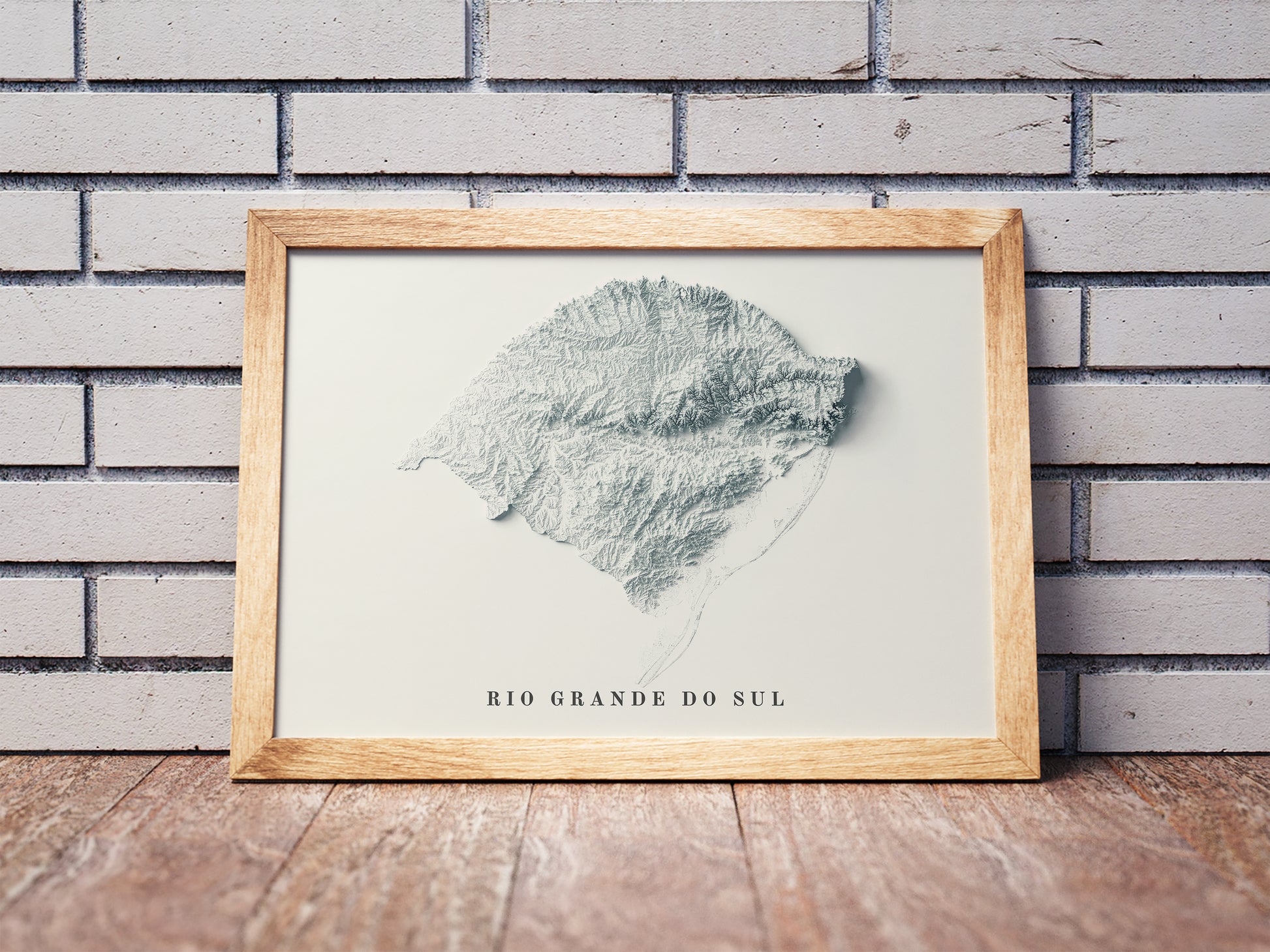 Vintage Rio Grande do Sul State shaded relief map in a wooden frame. Realistic terrain art print for home decor, displayed against a brick wall