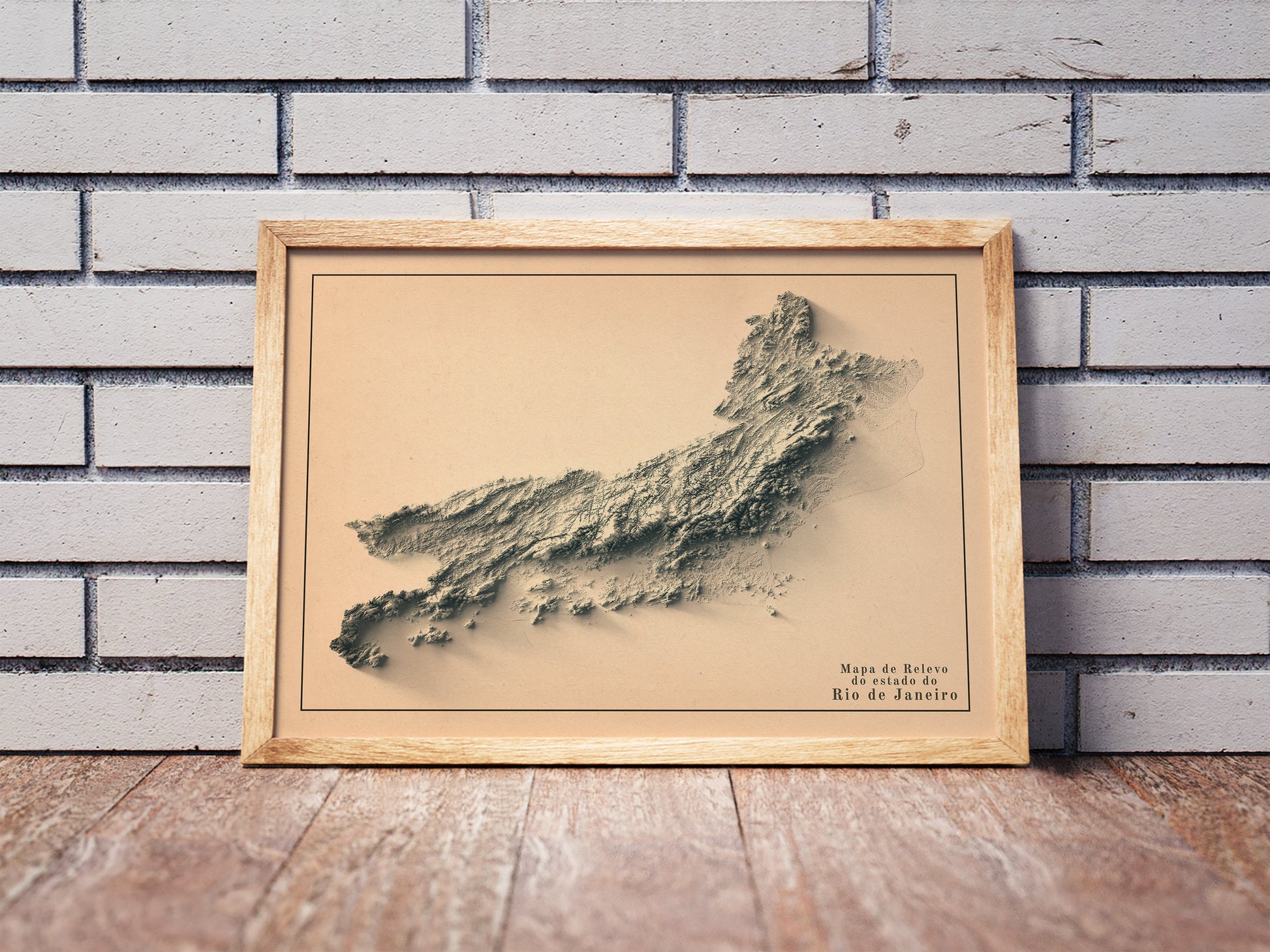 Vintage Rio de Janeiro State shaded relief map in a wooden frame. Realistic terrain art print for home decor, displayed against a brick wall