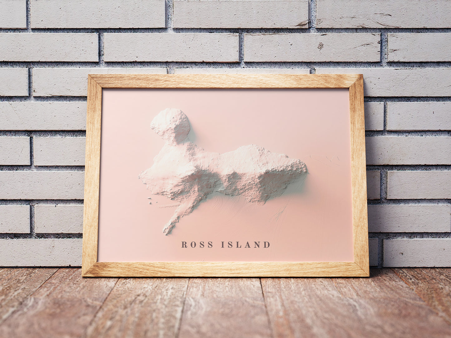 Vintage Ross Island (Antarctica) shaded relief map in a wooden frame. Realistic terrain art print for home decor, displayed against a brick wall