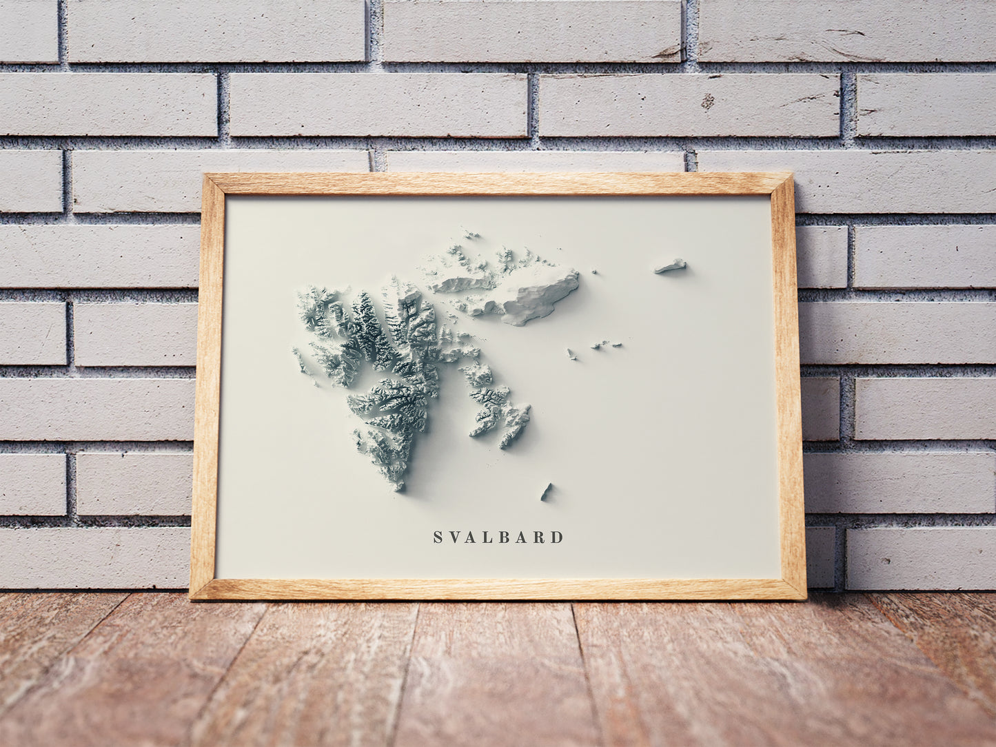 Svalbard, Norway, shaded relief map in a wooden frame. Realistic terrain art print for home decor, displayed against a brick wall