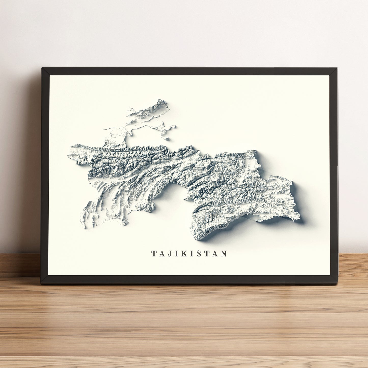 Tajikistan framed shaded relief map in black frame. Artistic print highlighting mountains with a realistic terrain effect