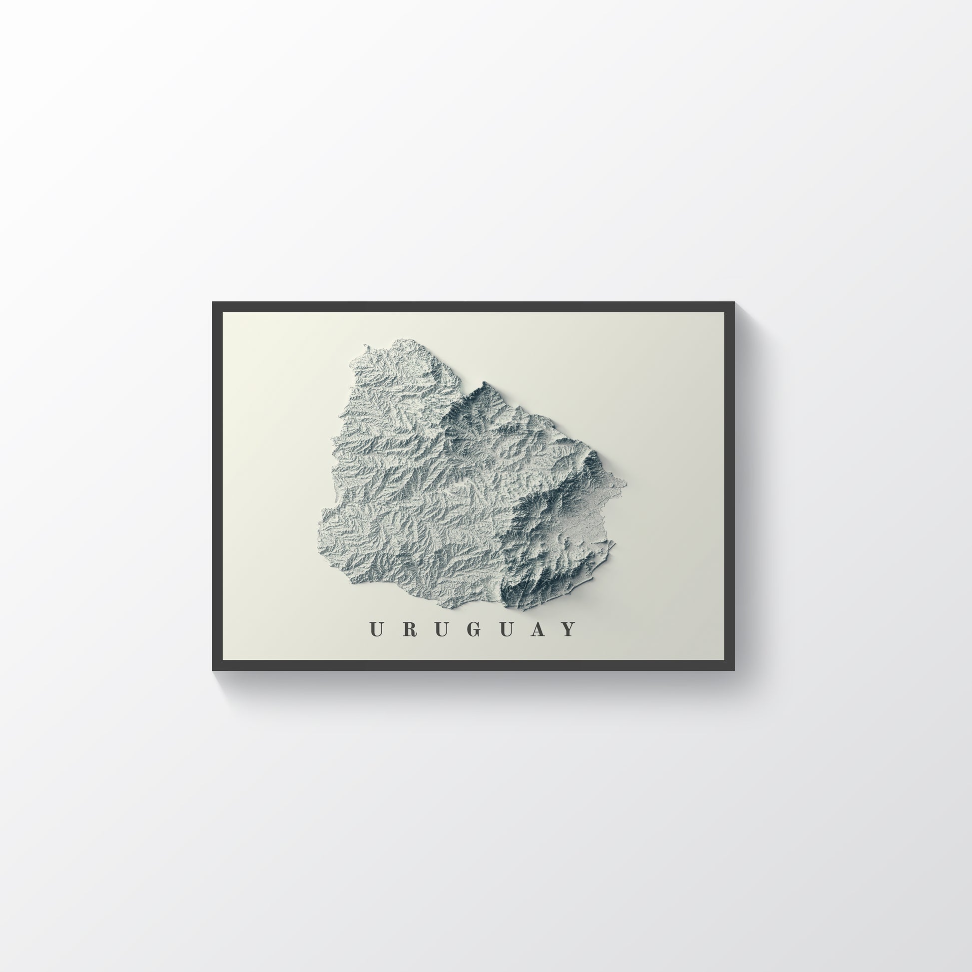 Uruguay shaded relief map in black frame. Realistic terrain art print for home decor, displayed on rustic wooden table
