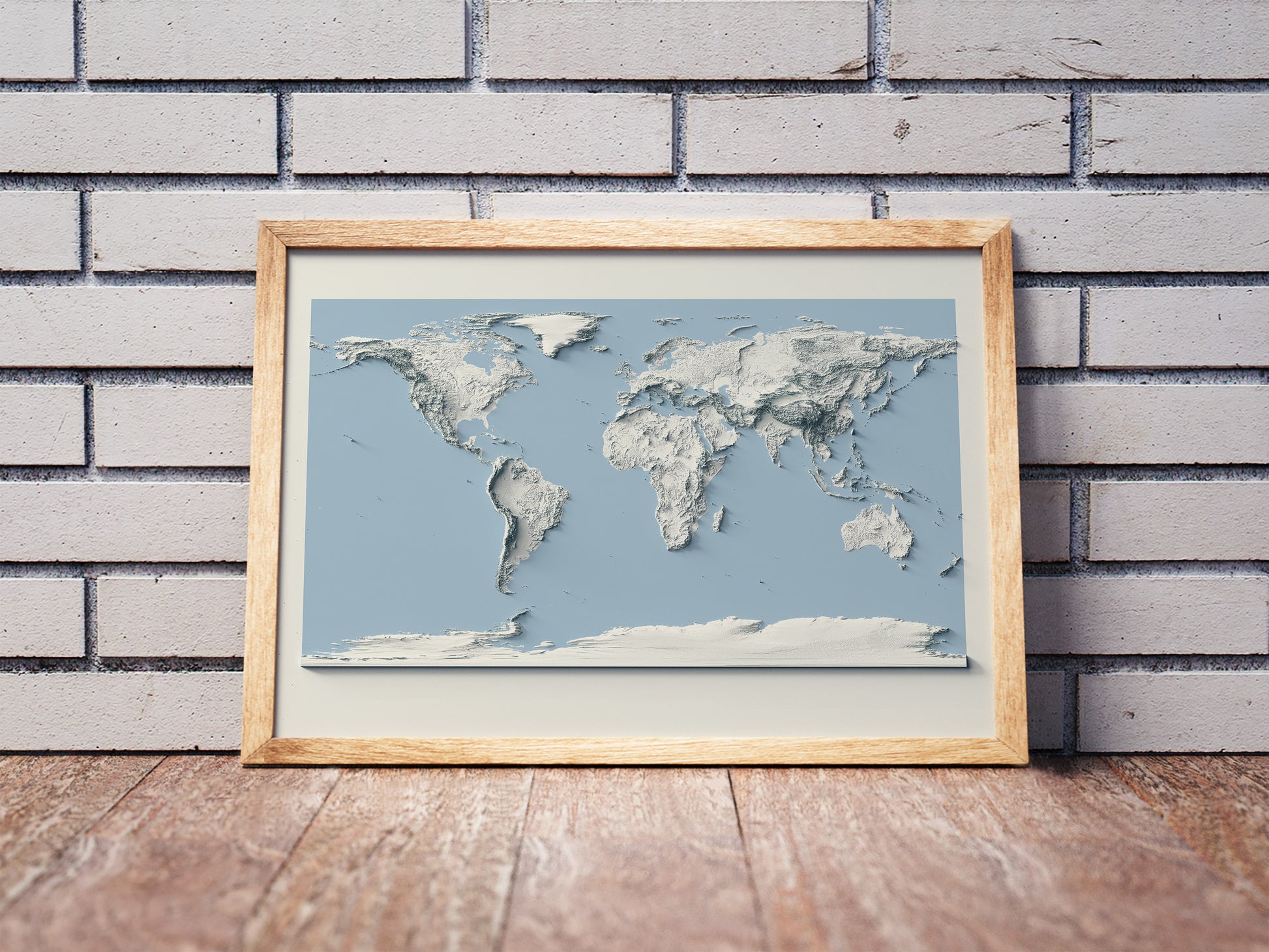 World shaded relief map and blue ocean in a wooden frame. Realistic terrain art print