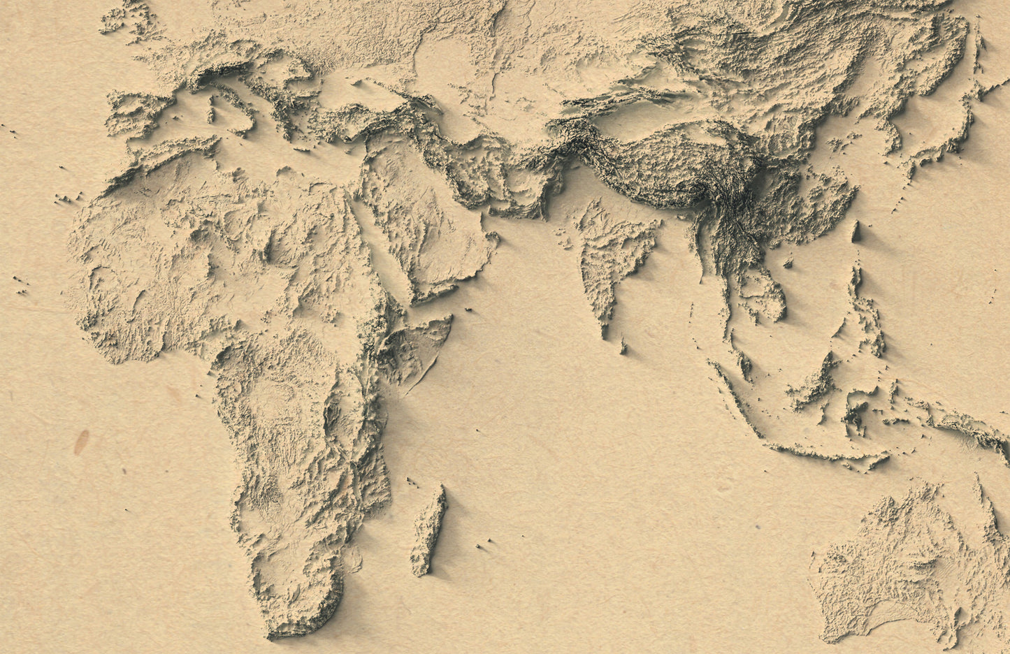 Detailed close-up of a vintage World relief map, showcasing textured topography and geographic contours