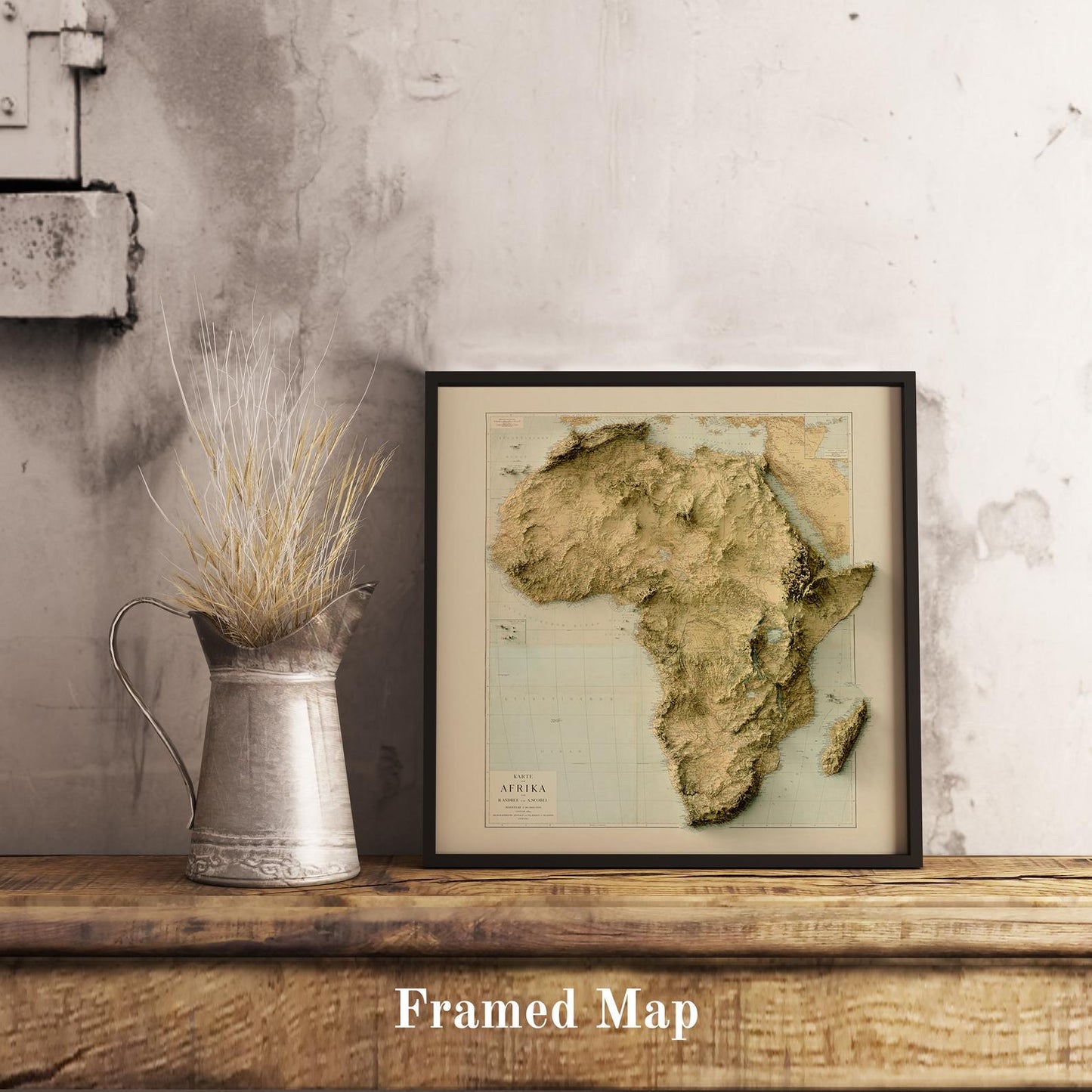 Vintage Africa shaded relief map in black frame. Realistic terrain art print for home decor, displayed on rustic wooden table
