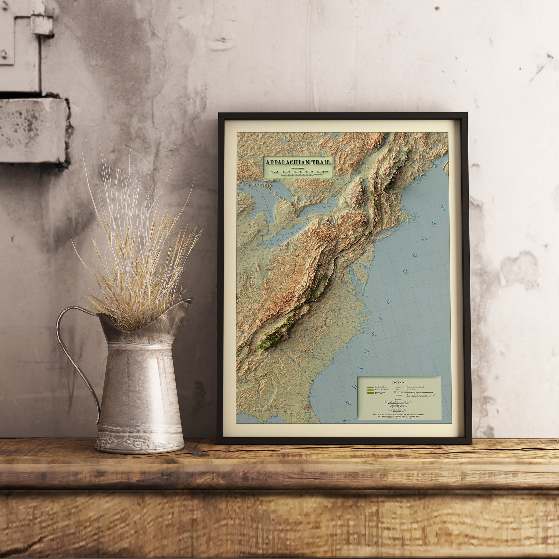 Vintage Appalachian Trail shaded relief map in black frame. Realistic terrain art print for home decor, displayed on rustic wooden table