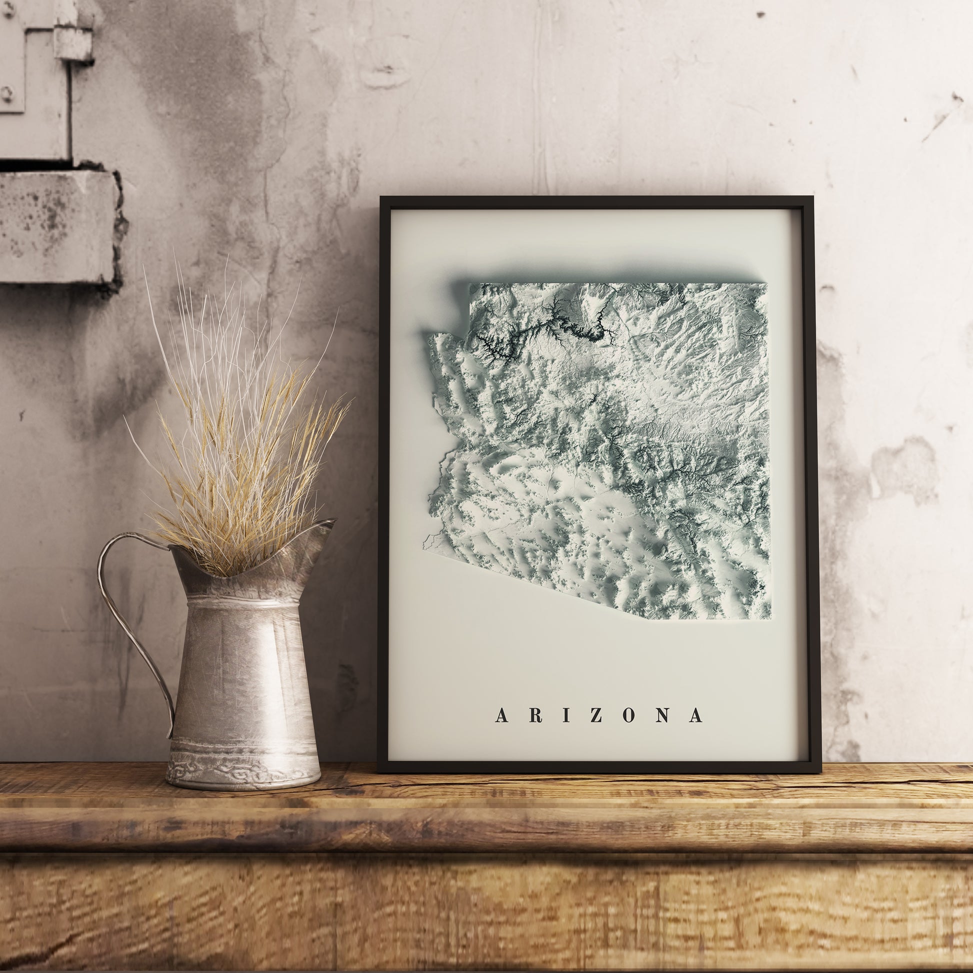 Arizona (USA) shaded relief map in black frame. Realistic terrain art print for home decor, displayed on rustic wooden table