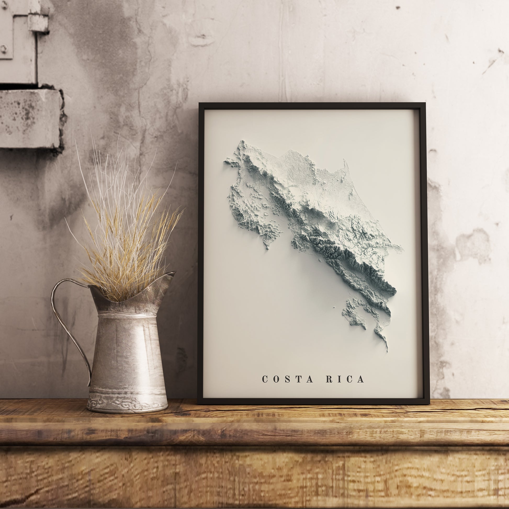 Costa Rica shaded relief map in black frame. Realistic terrain art print for home decor, displayed on rustic wooden table
