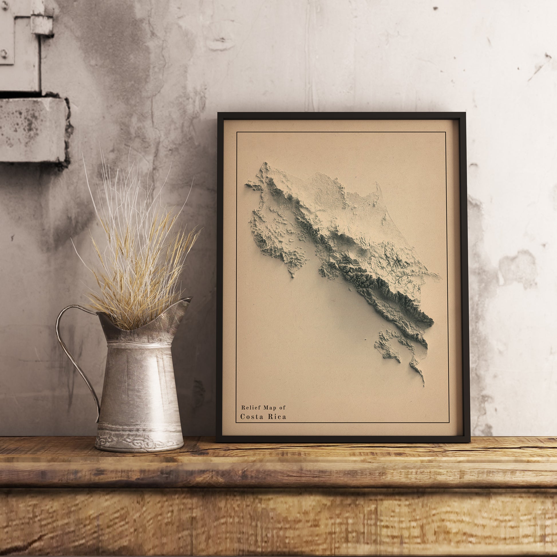 Vintage Costa Rica shaded relief map in black frame. Realistic terrain art print for home decor, displayed on rustic wooden table