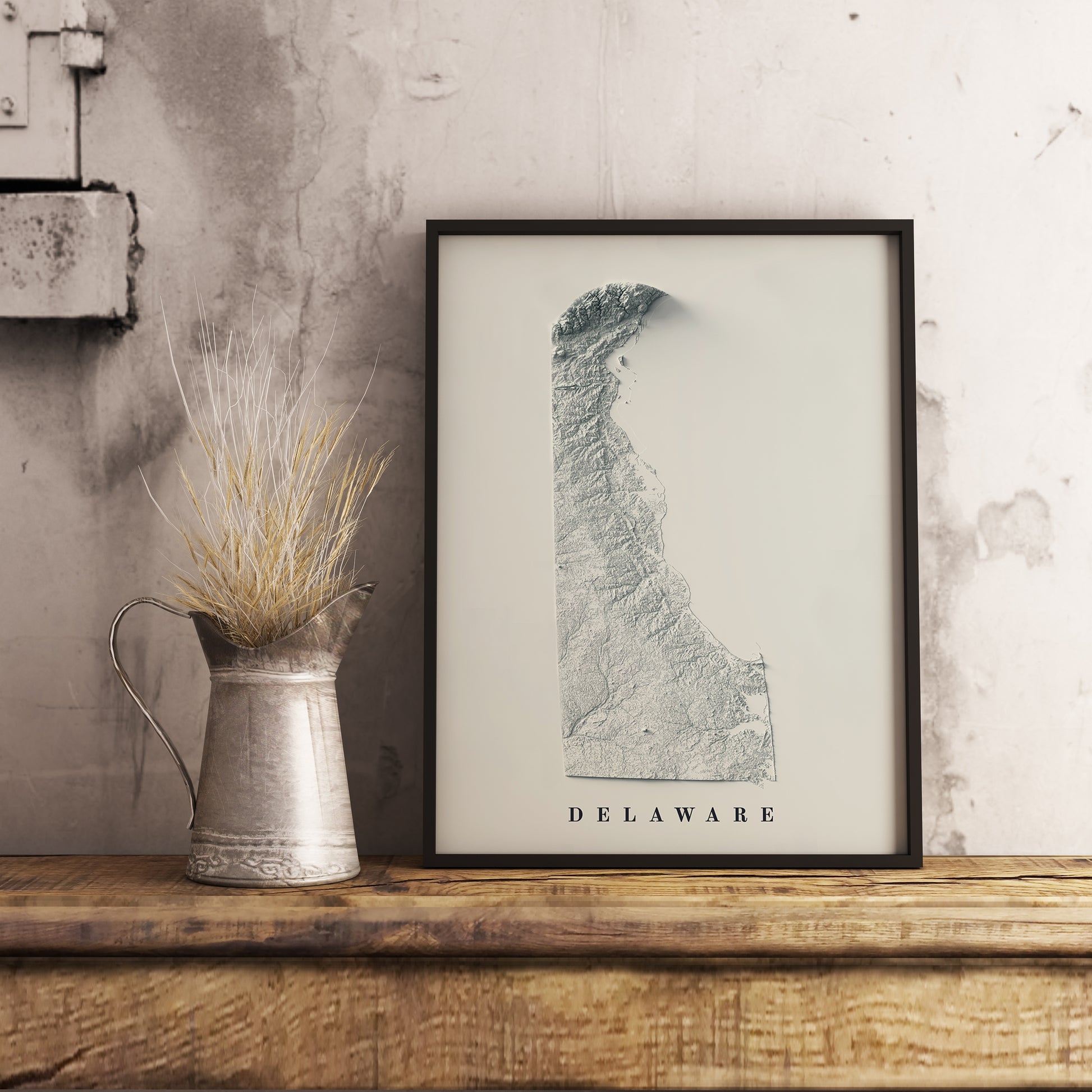 Vintage Delaware (USA) shaded relief map in black frame. Realistic terrain art print for home decor, displayed on rustic wooden table