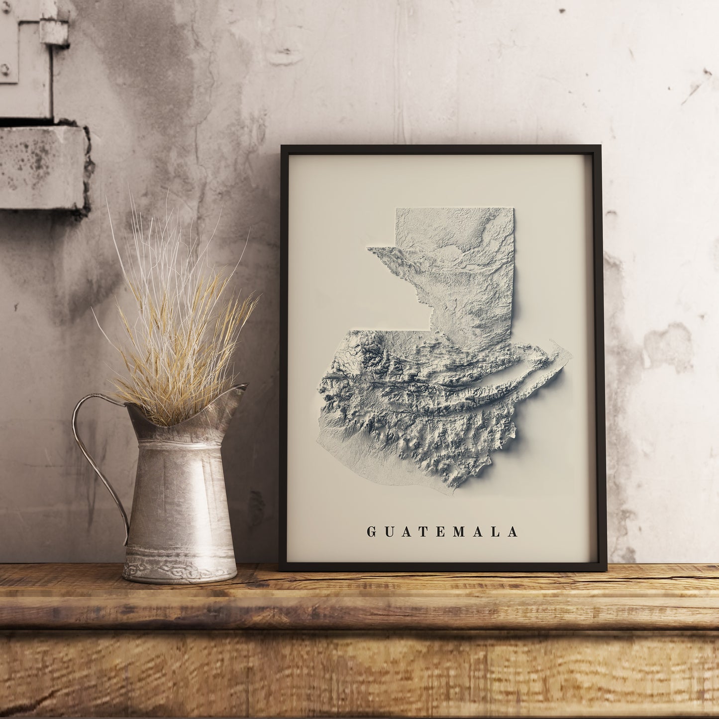 Vintage Guatemala shaded relief map in black frame. Realistic terrain art print for home decor, displayed on rustic wooden table