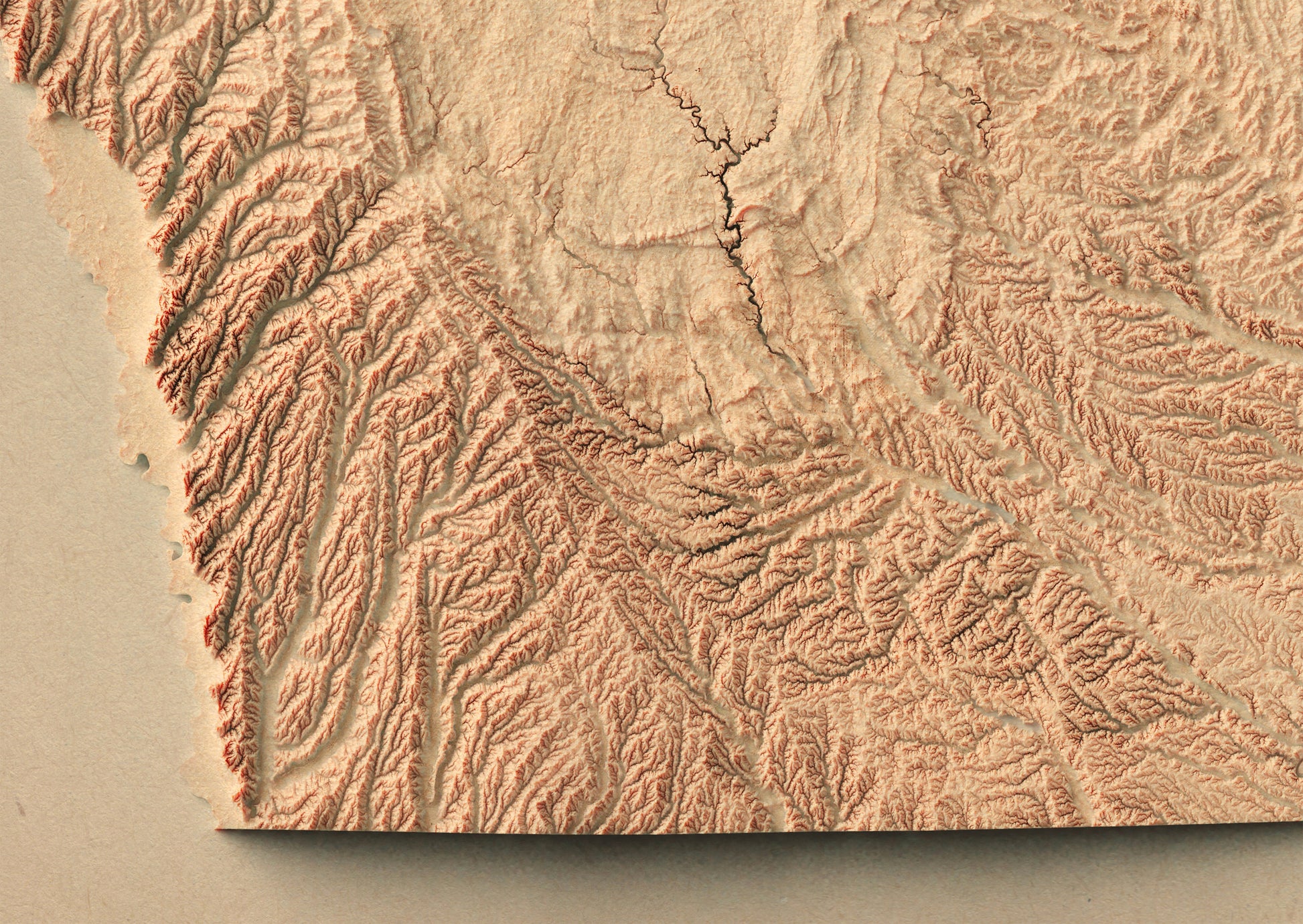 Detailed close-up of a vintage Iowa (USA) relief map, showcasing textured topography and geographic contours