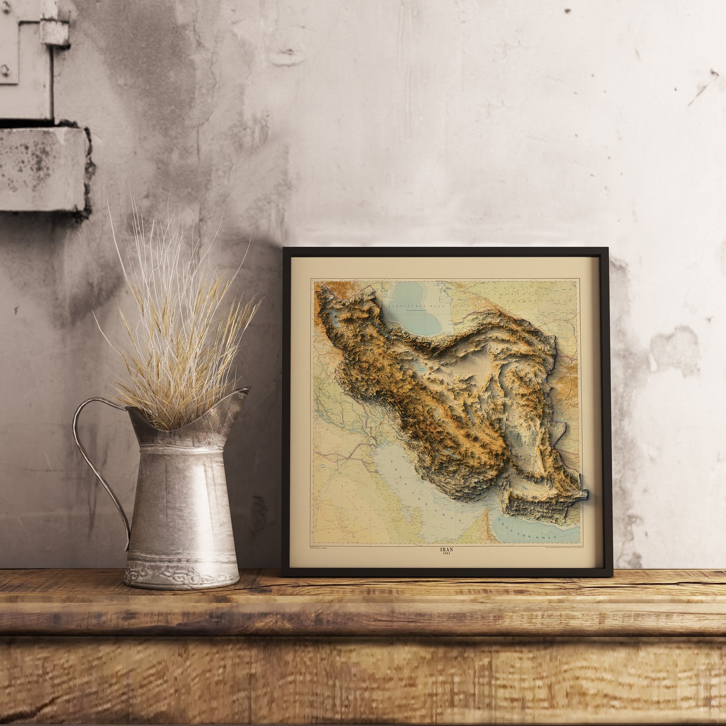 Vintage Iran shaded relief map in black frame. Realistic terrain art print for home decor, displayed on rustic wooden table