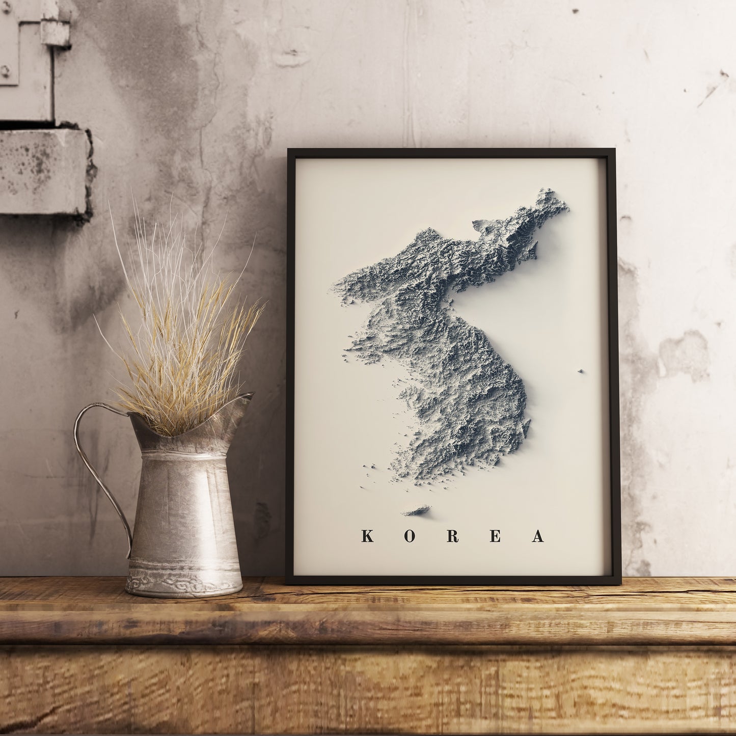 North and South Koreas shaded relief map in black frame. Realistic terrain art print for home decor, displayed on rustic wooden table
