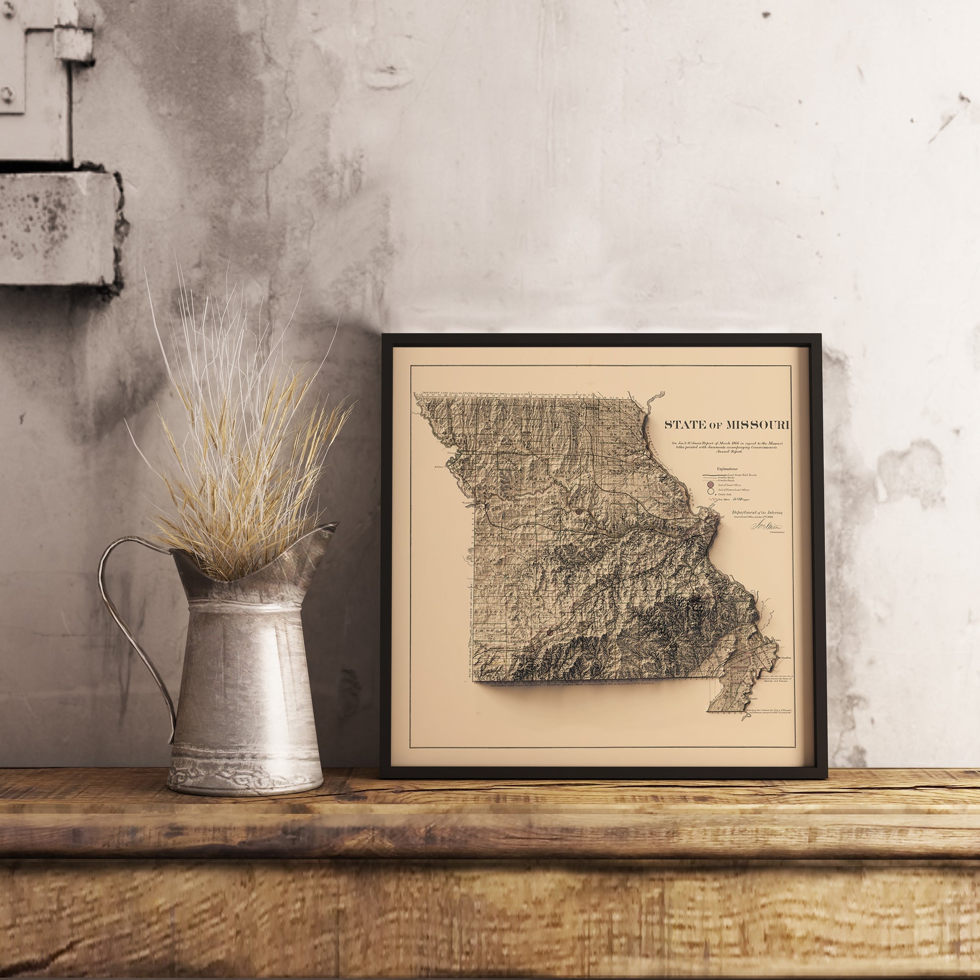 Vintage Missouri (USA) shaded relief map in black frame. Realistic terrain art print for home decor, displayed on rustic wooden table