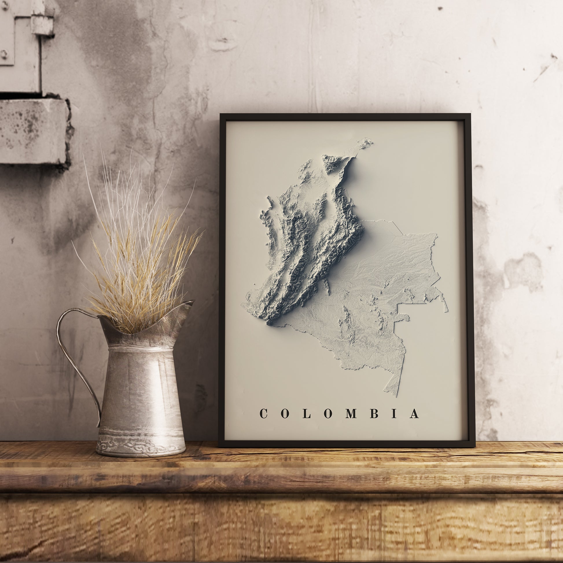 Colombia shaded relief map in black frame. Realistic terrain art print for home decor, displayed on rustic wooden table