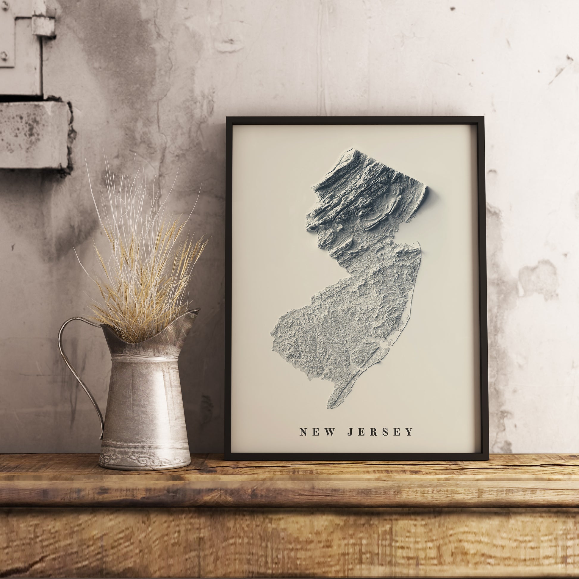 New Jersey (USA) shaded relief map in black frame. Realistic terrain art print for home decor, displayed on rustic wooden table
