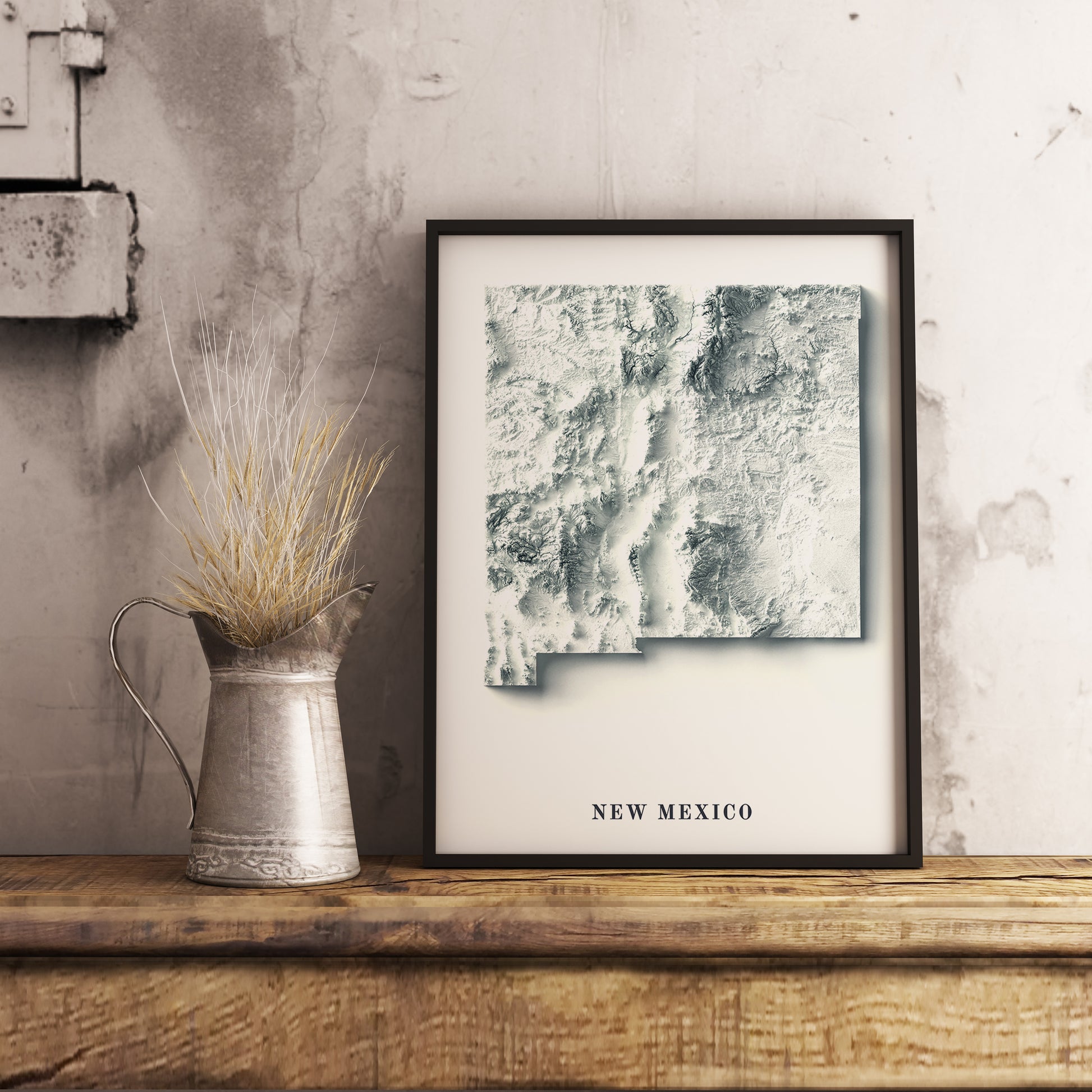 New Mexico (USA) shaded relief map in black frame. Realistic terrain art print for home decor, displayed on rustic wooden table