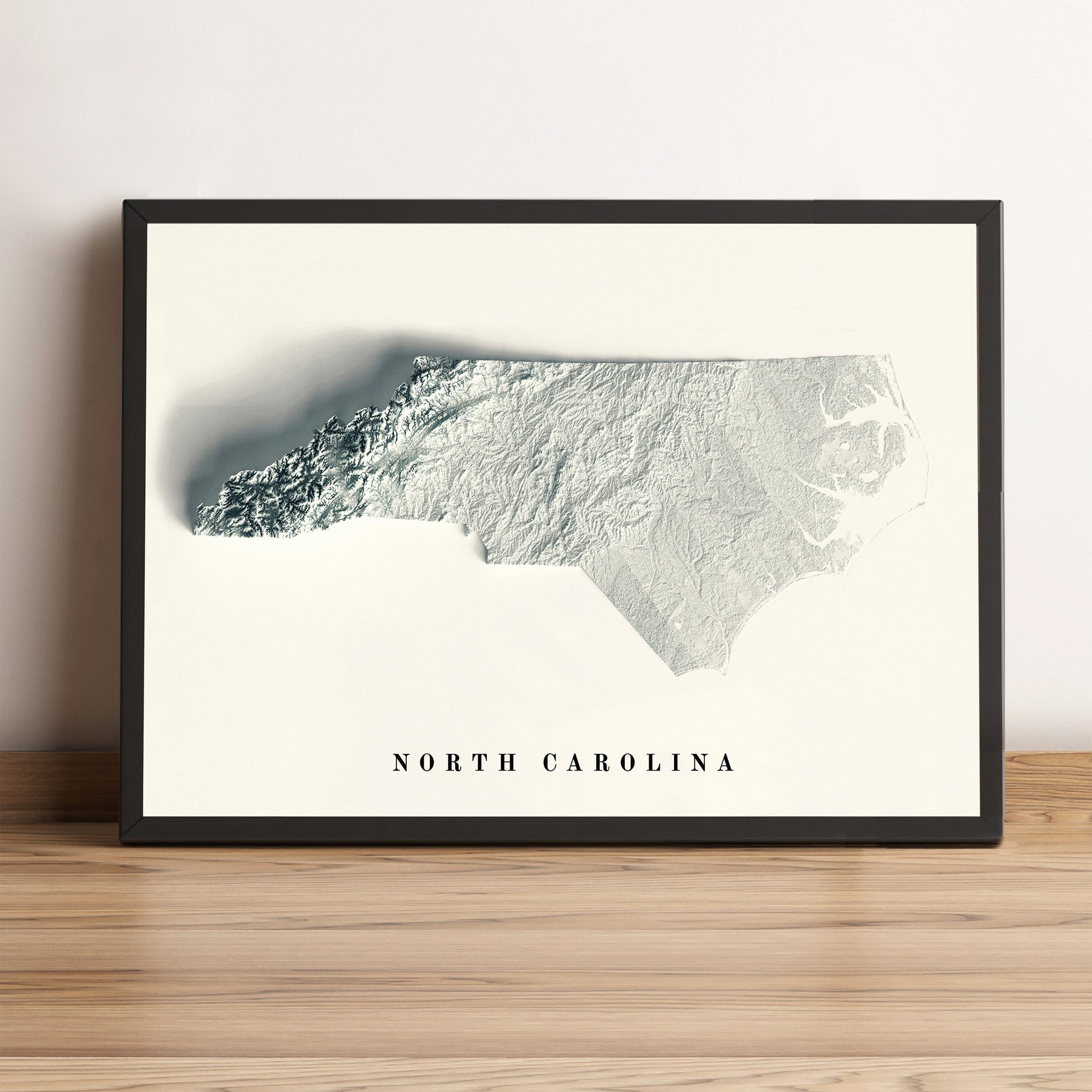 North Carolina (USA) framed shaded relief map in black frame. Artistic print highlighting mountains with a realistic terrain effect
