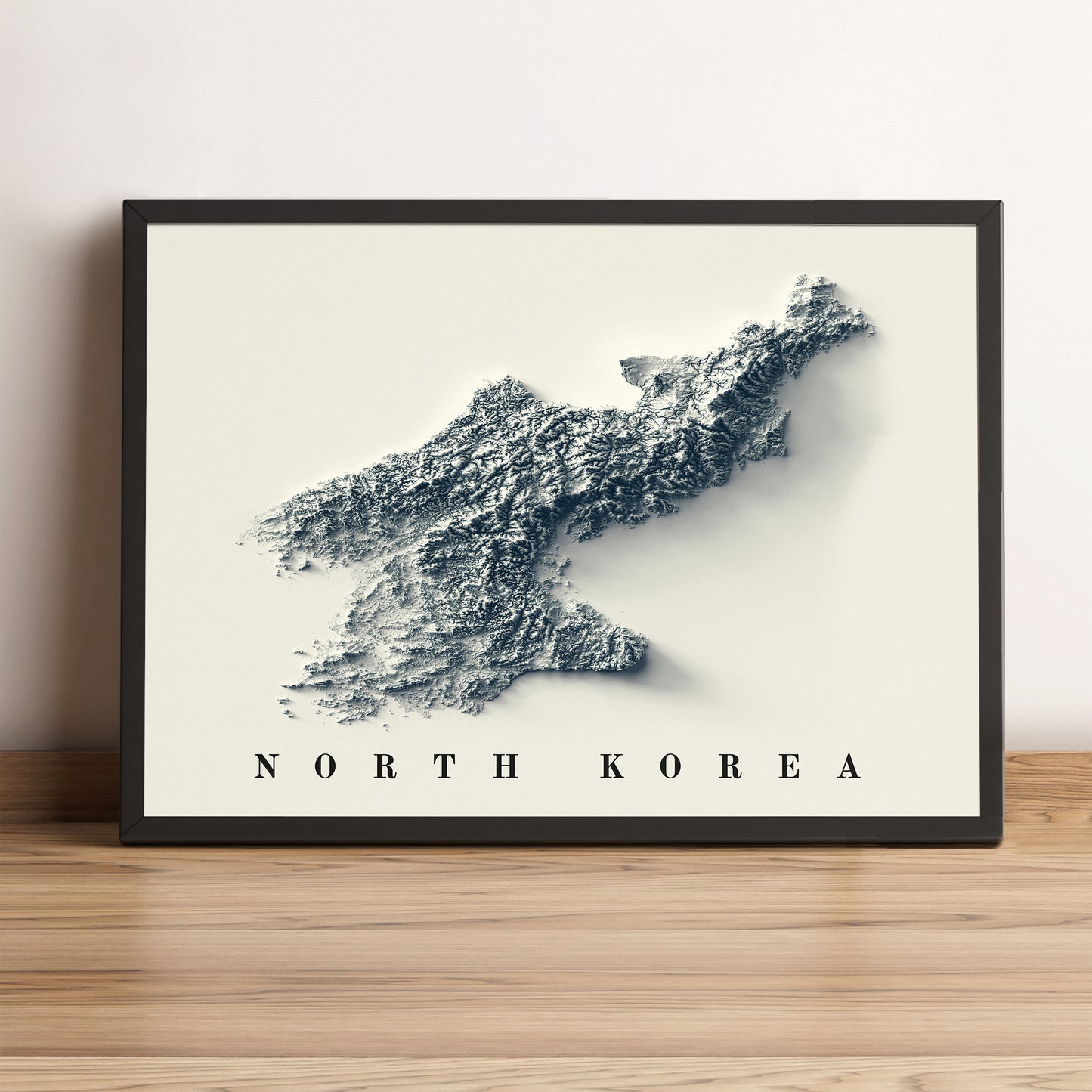 North Korea framed shaded relief map in black frame. Artistic print highlighting mountains with a realistic terrain effect