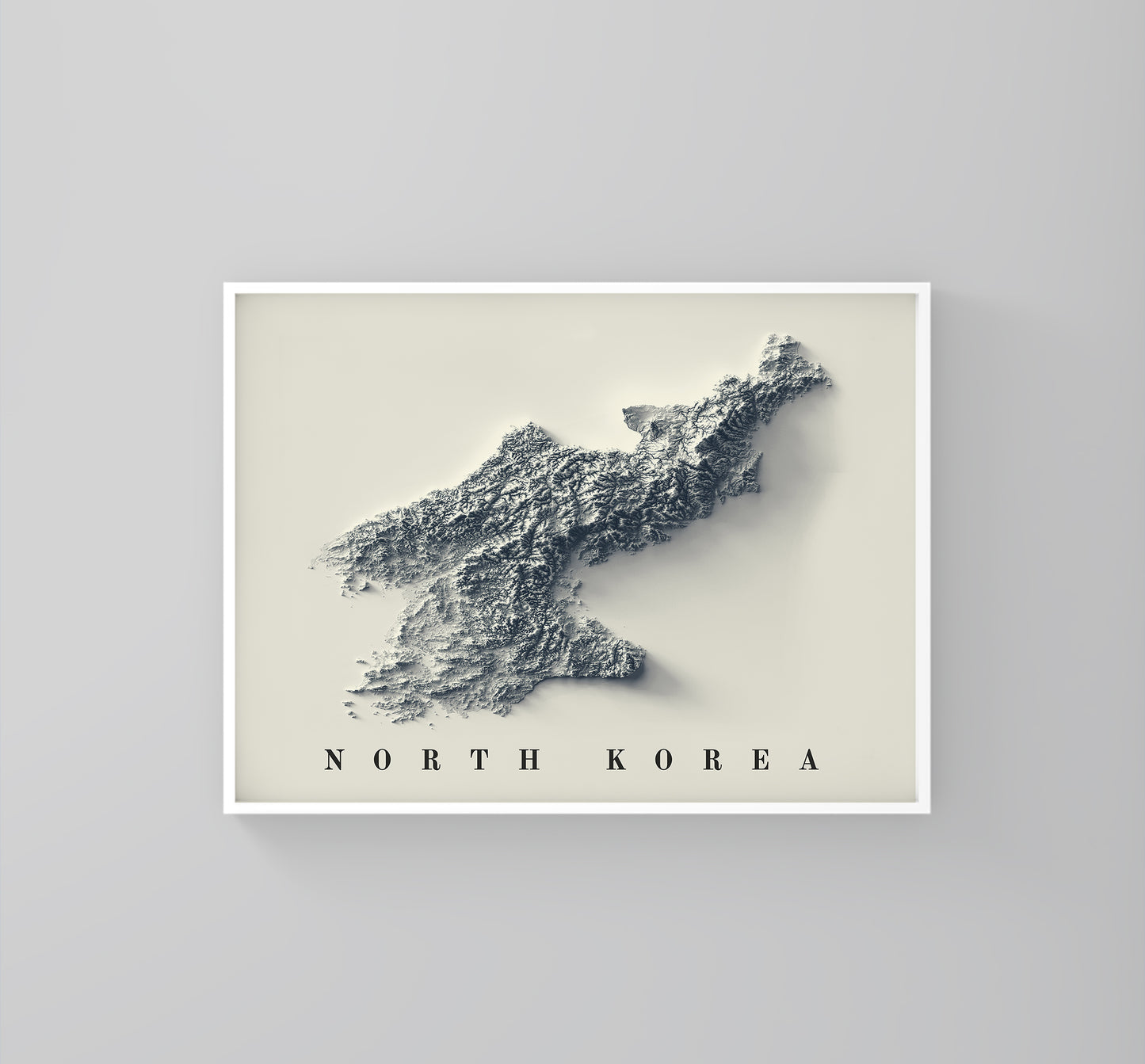 North Korea framed shaded relief map in white frame. Artistic print highlighting mountains with a realistic 3d effect
