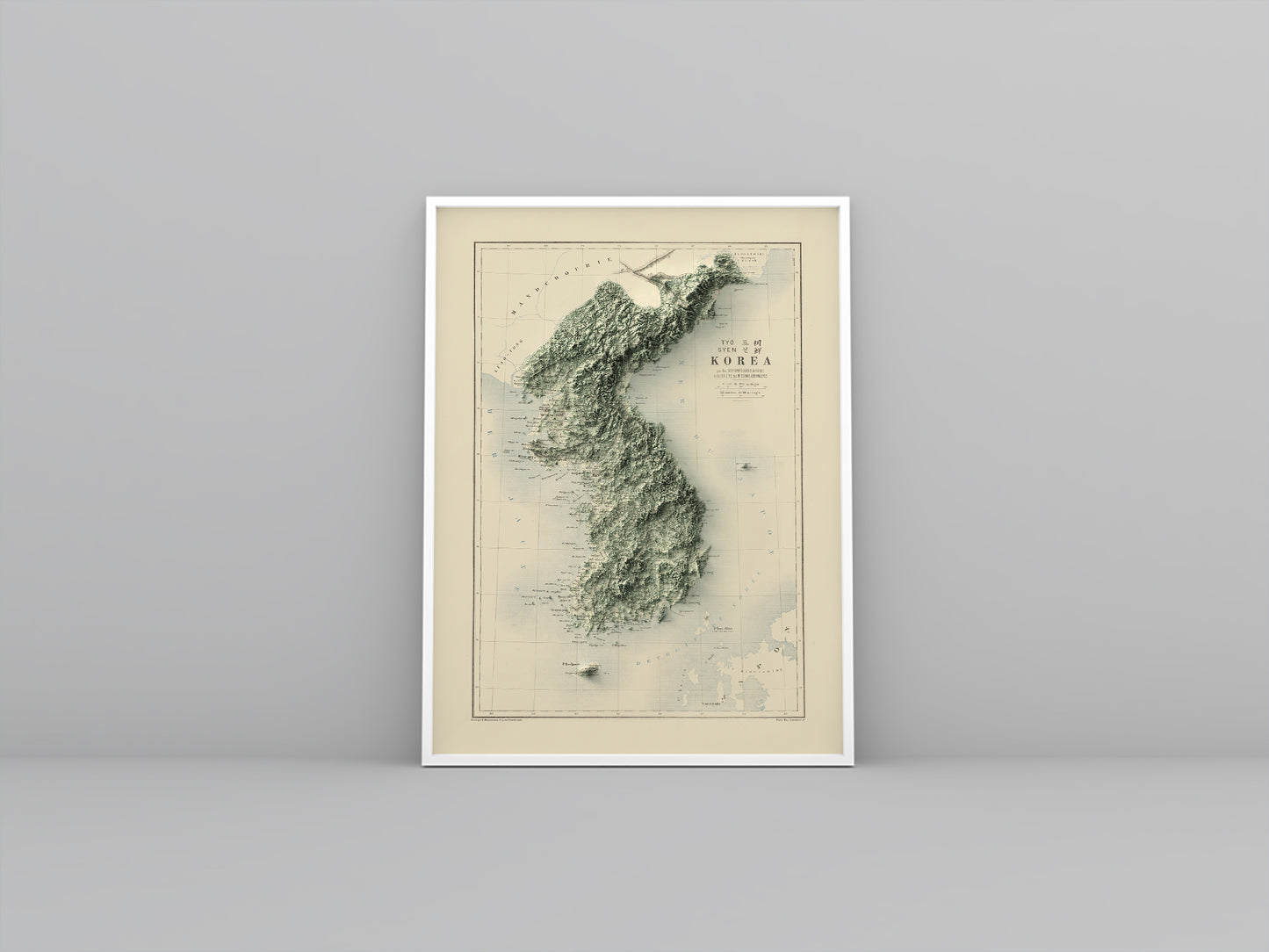 North and South Koreas vintage framed shaded relief map in white frame. Artistic print highlighting mountains with a realistic 3d effect