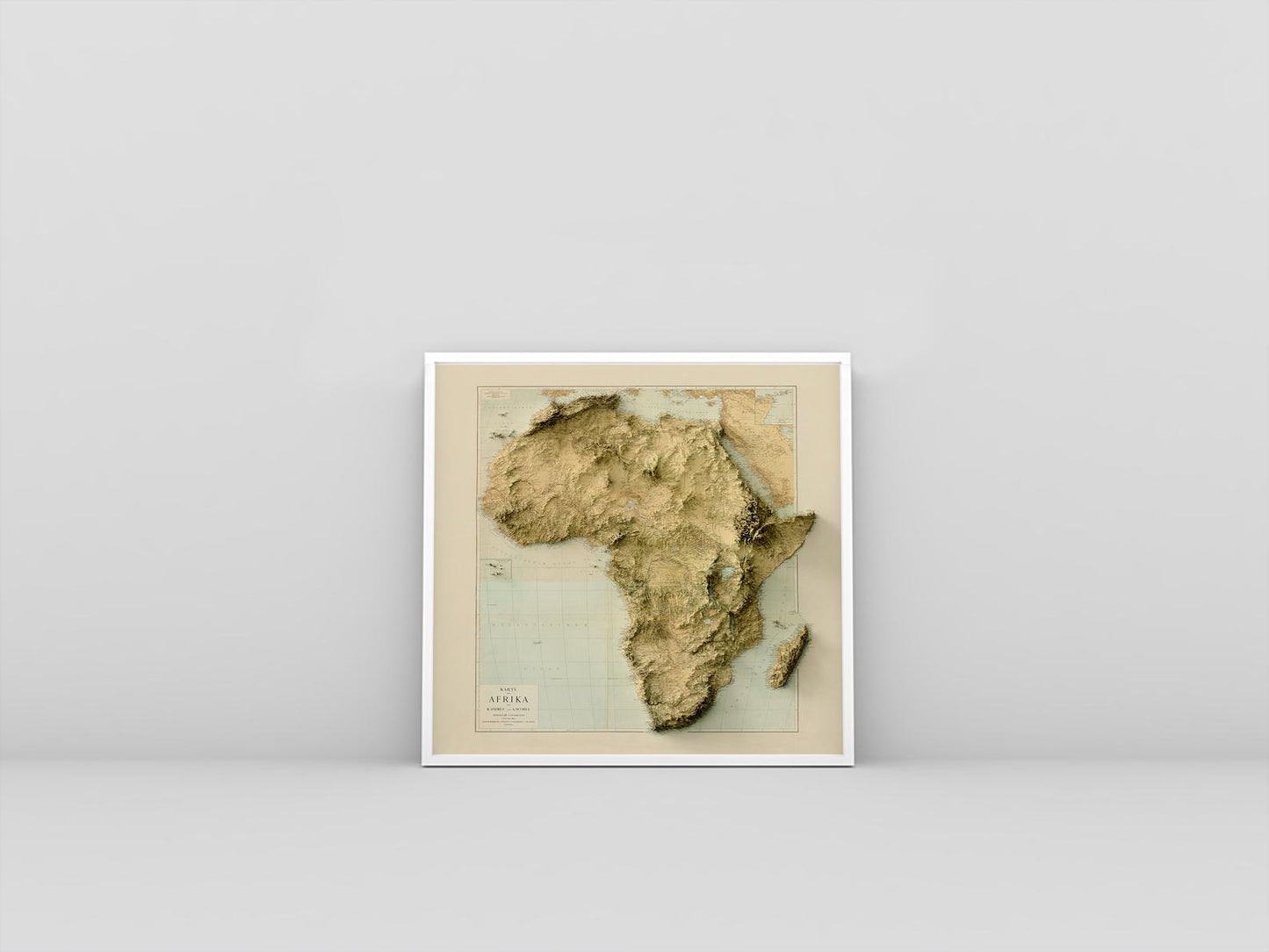 Africa vintage framed shaded relief map in white frame. Artistic print highlighting mountains with a realistic 3d effect