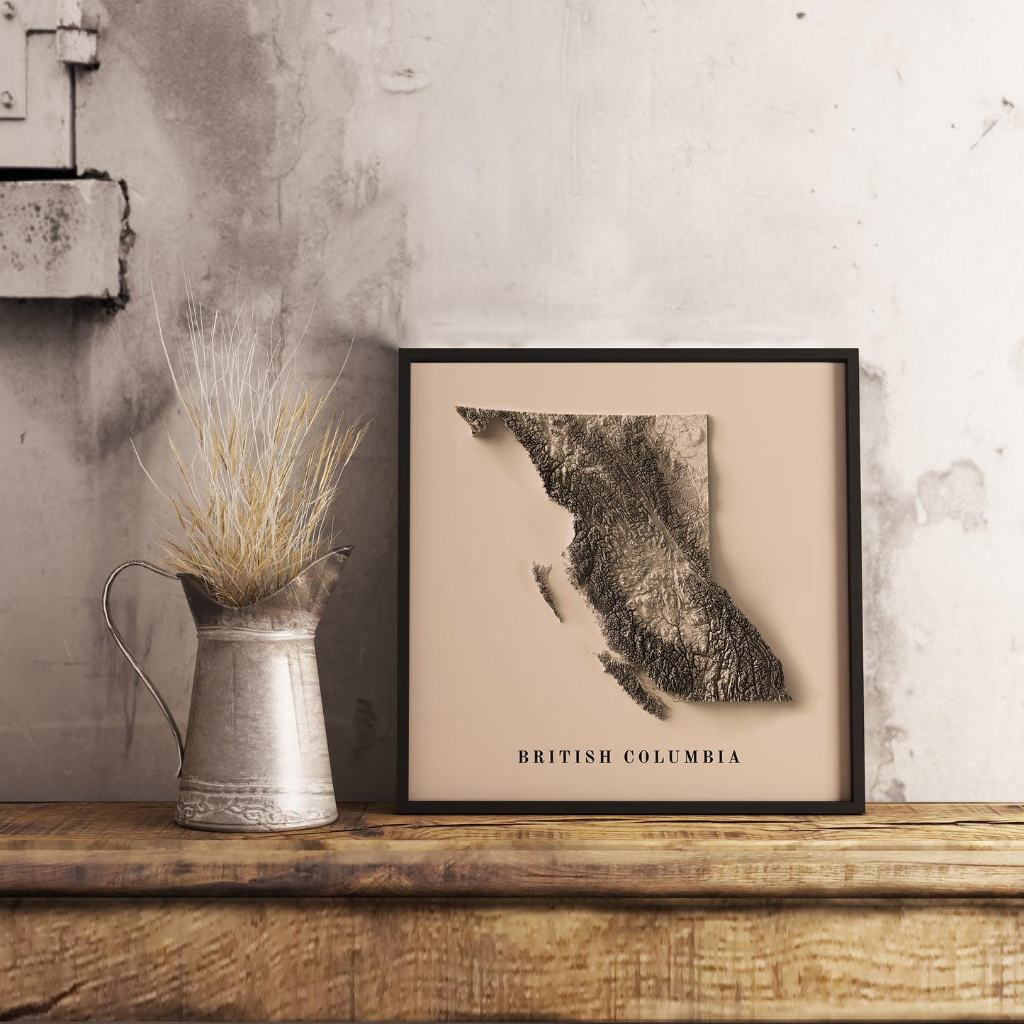 British Columbia (Canada) shaded relief map in black frame. Realistic terrain art print for home decor, displayed on rustic wooden table