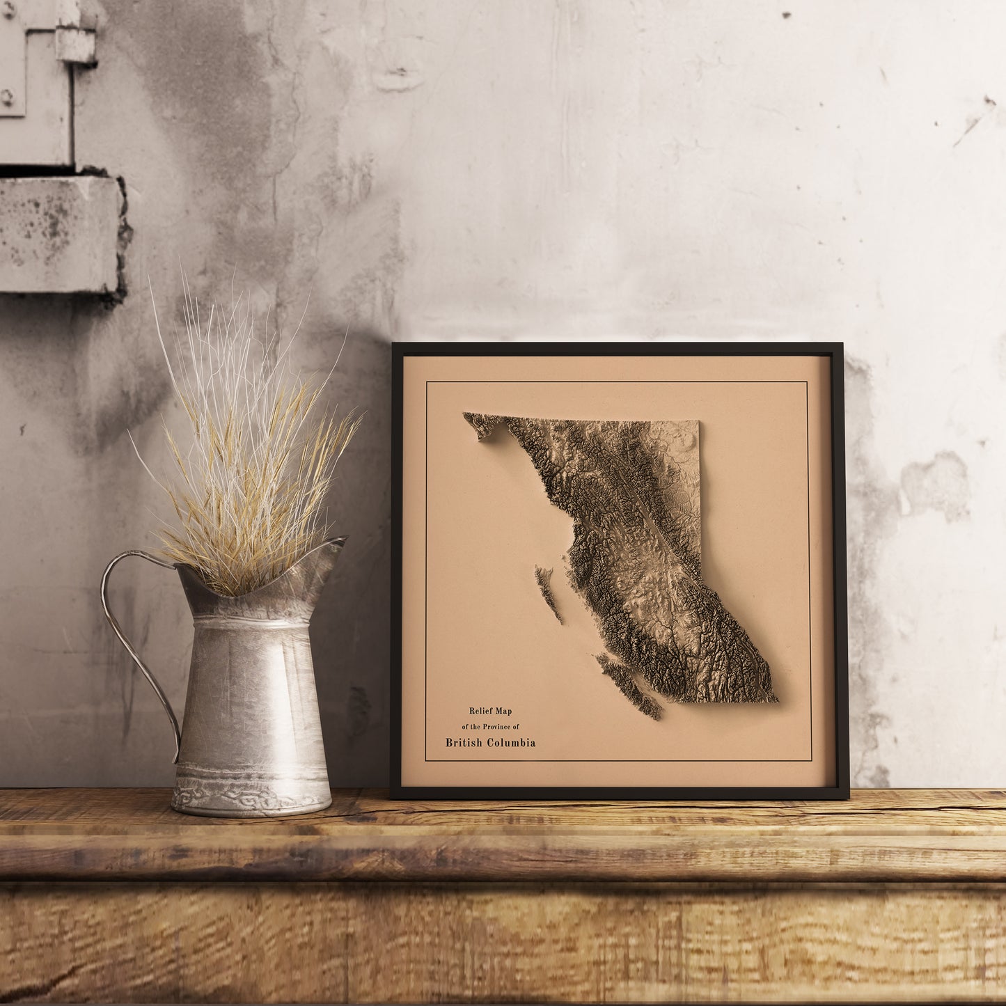Vintage British Columbia (Canada) shaded relief map in black frame. Realistic terrain art print for home decor, displayed on rustic wooden table