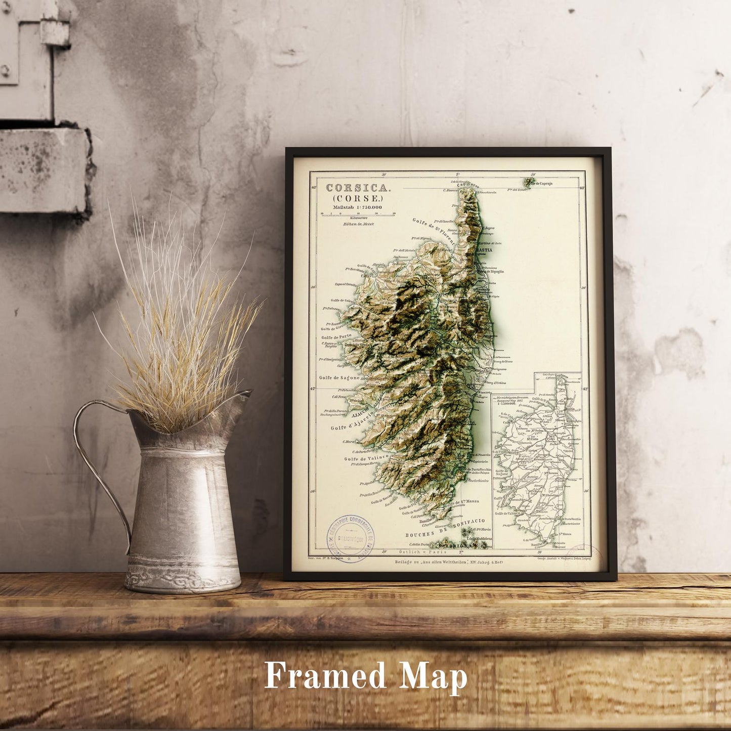 Vintage Corsica (France) shaded relief map in black frame. Realistic terrain art print for home decor, displayed on rustic wooden table
