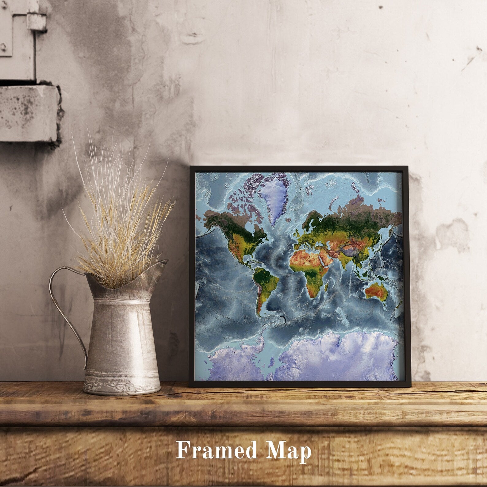 World shaded relief map in black frame, featuring the Mercator Projection. Terrain art print for home decor, displayed on rustic wooden table
