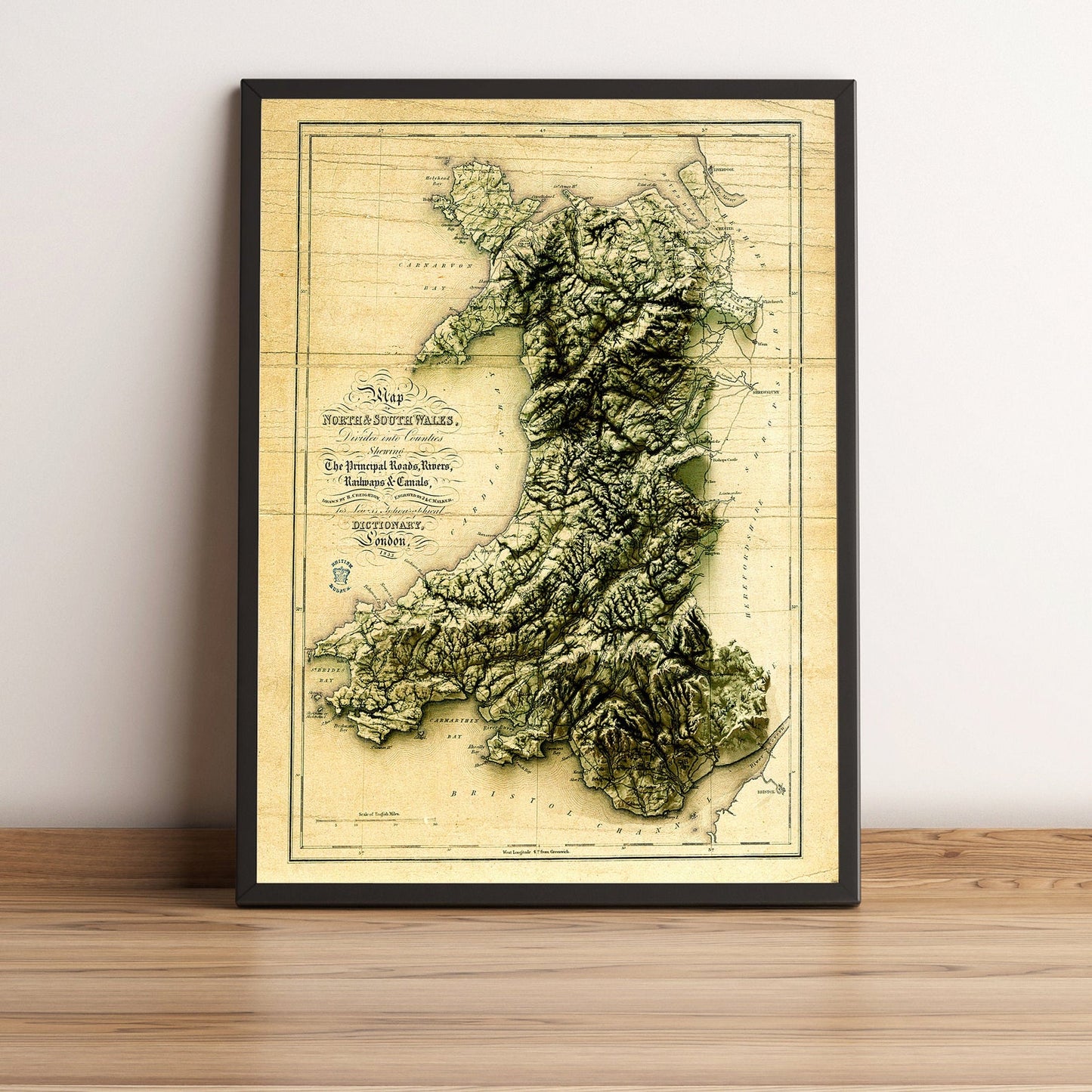 Wales vintage framed shaded relief map in black frame. Artistic print highlighting mountains with a realistic terrain effect