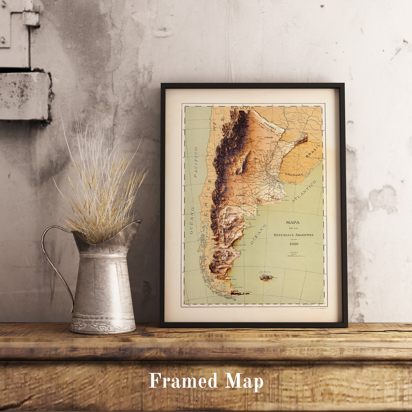Vintage Argentina shaded relief map in black frame. Realistic terrain art print for home decor, displayed on rustic wooden table