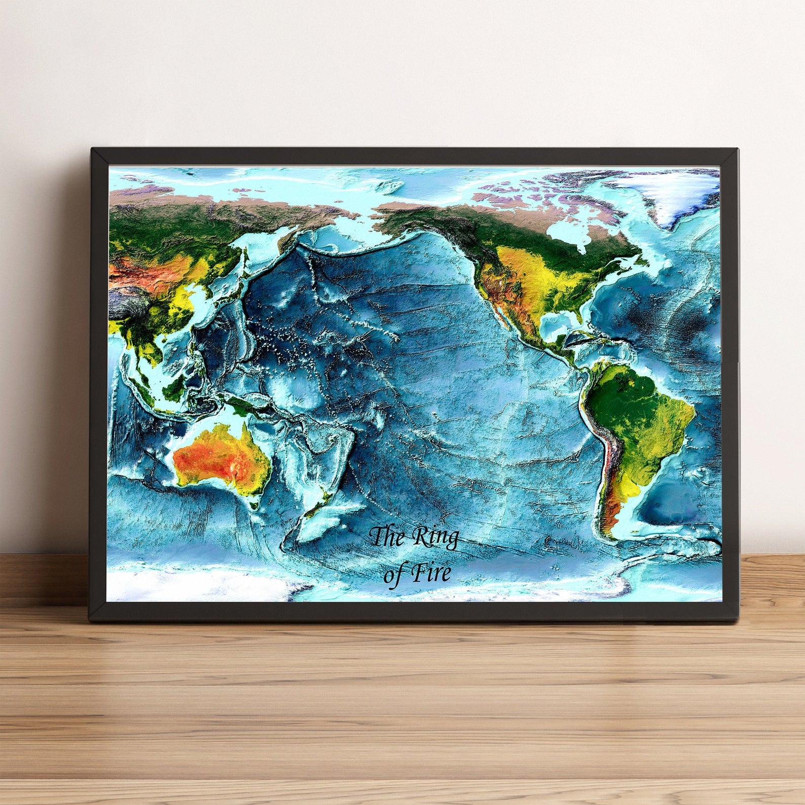 Pacific Ocean, Ring of Fire framed shaded relief map in black frame. Artistic print highlighting mountains with a realistic terrain effect