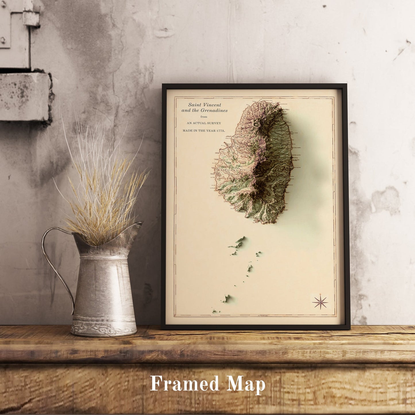 Saint Vincent and the Grenadines shaded relief map in black frame. Realistic terrain art print for home decor, displayed on rustic wooden table