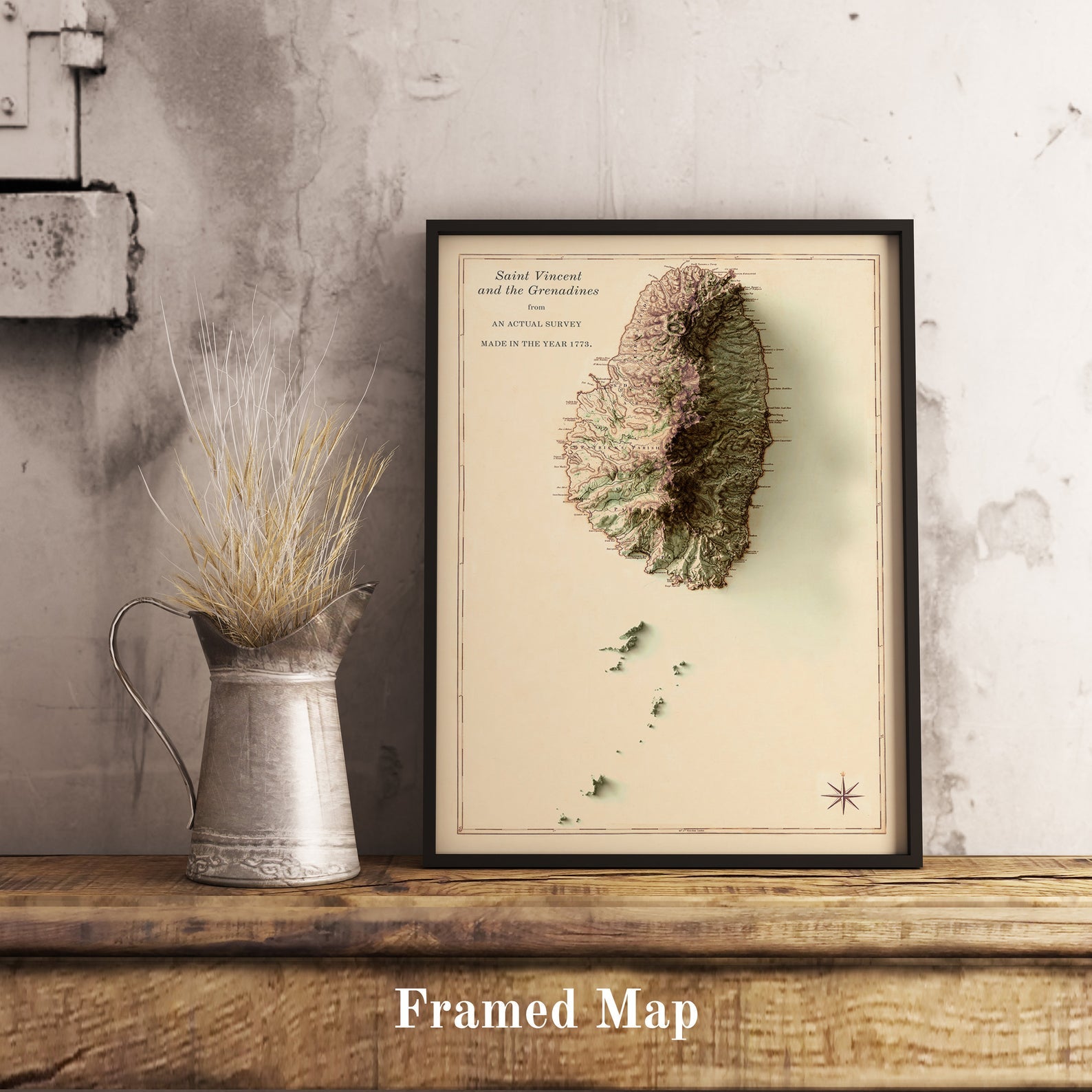 Saint Vincent and the Grenadines shaded relief map in black frame. Realistic terrain art print for home decor, displayed on rustic wooden table